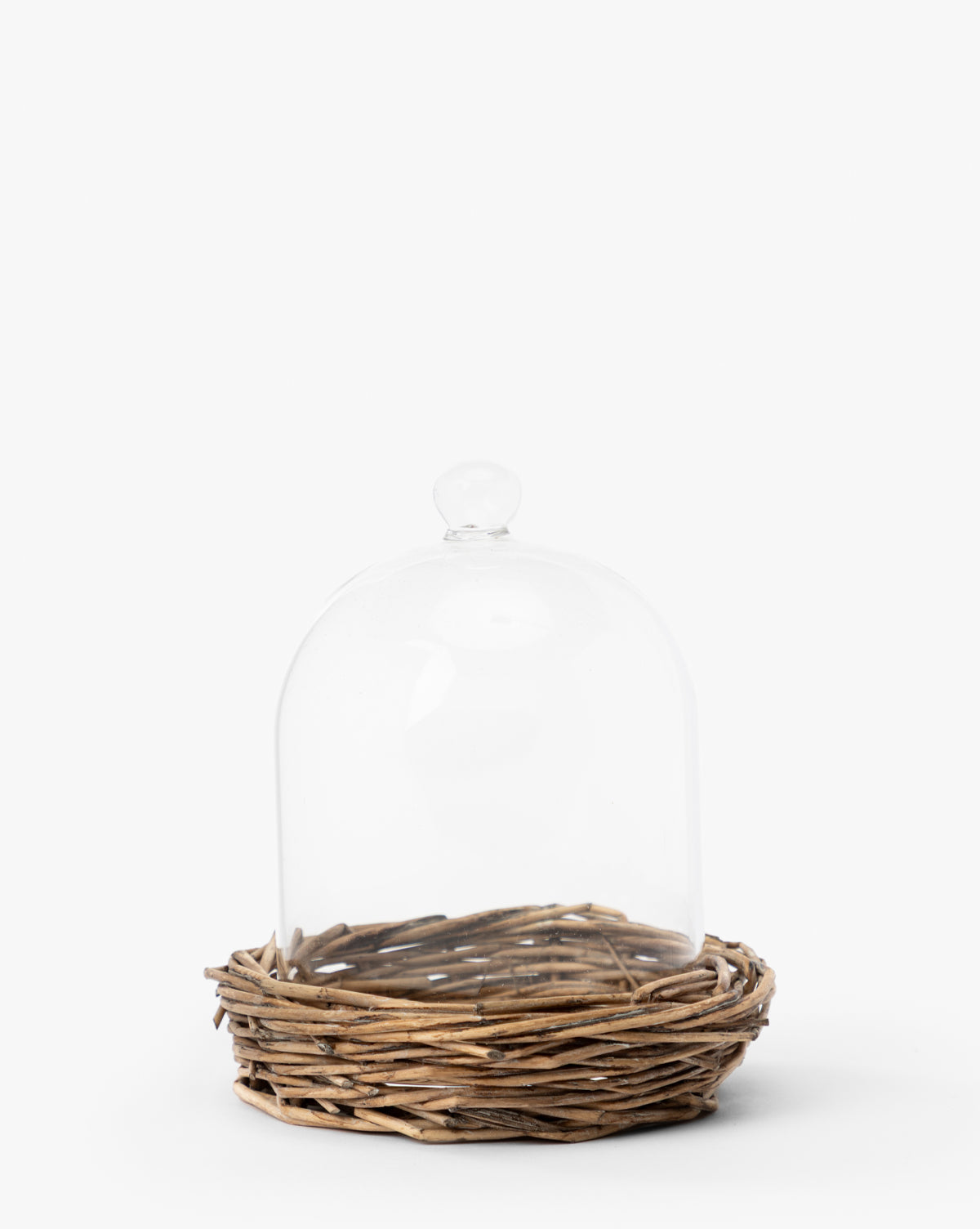 The Glass Cloche with Woven Base features a small dome and round handle atop a nest-like woven bottom, making it an ideal decorative accent for displays on a plain white background, by McGee & Co.