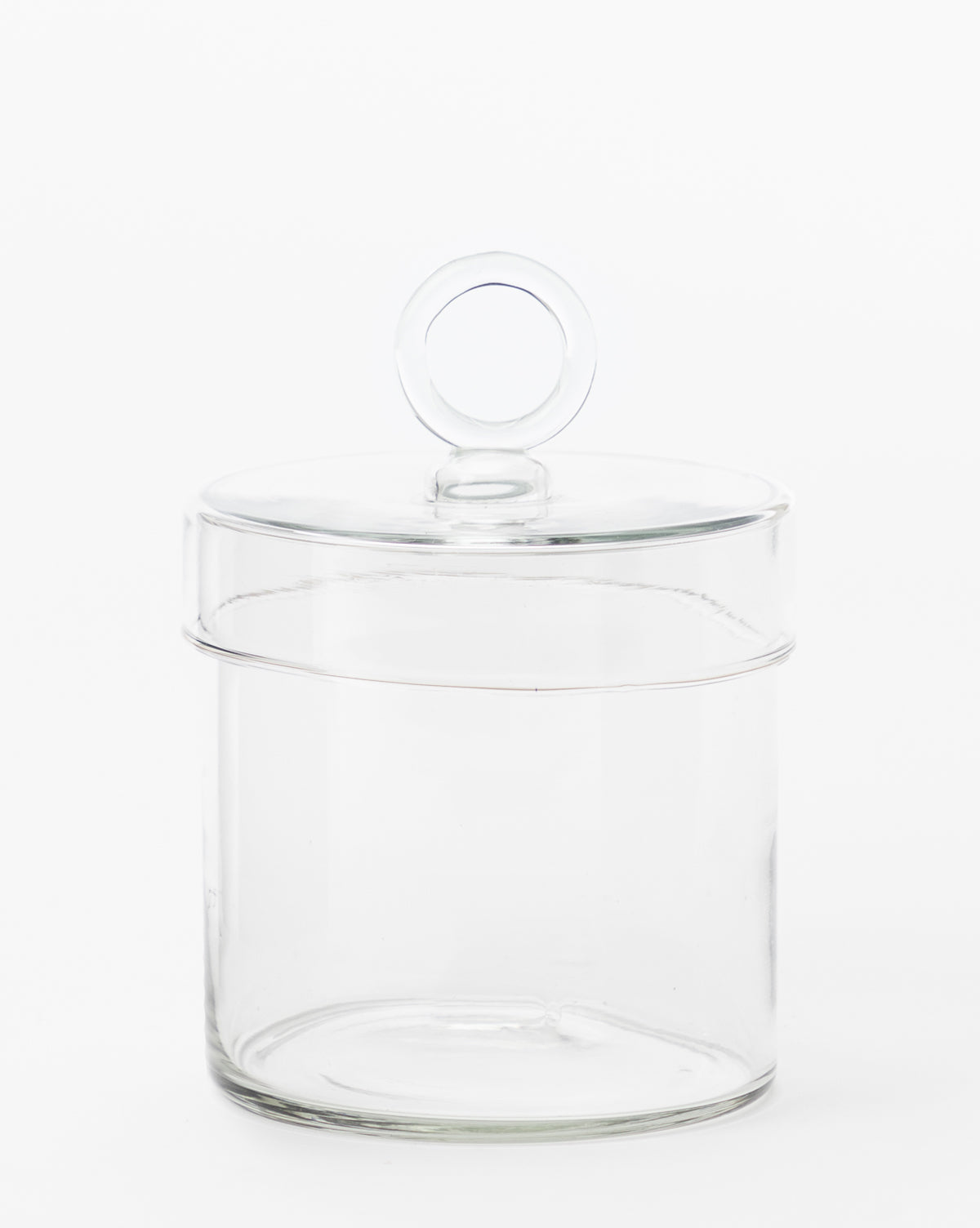 The Glass Lidded Canister, featuring a matching lid with a round handle, is pictured against a plain white background—ideal for organizing essentials on your bathroom countertop.