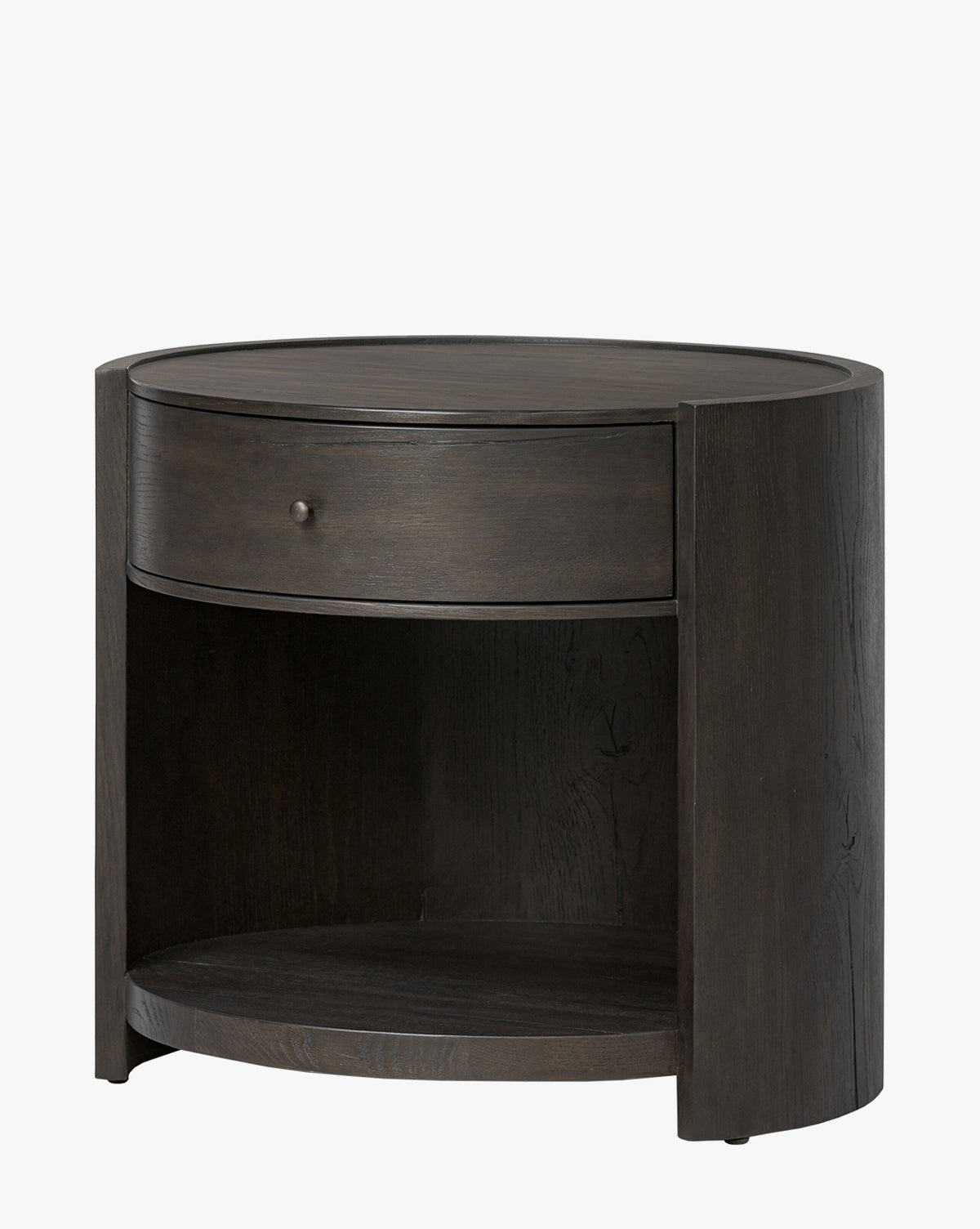 The Glenndon Oak Nightstand is a round bedside table with a black finish, featuring modern lines, a single drawer with a round knob, and an open shelf below, by McGee & Co.