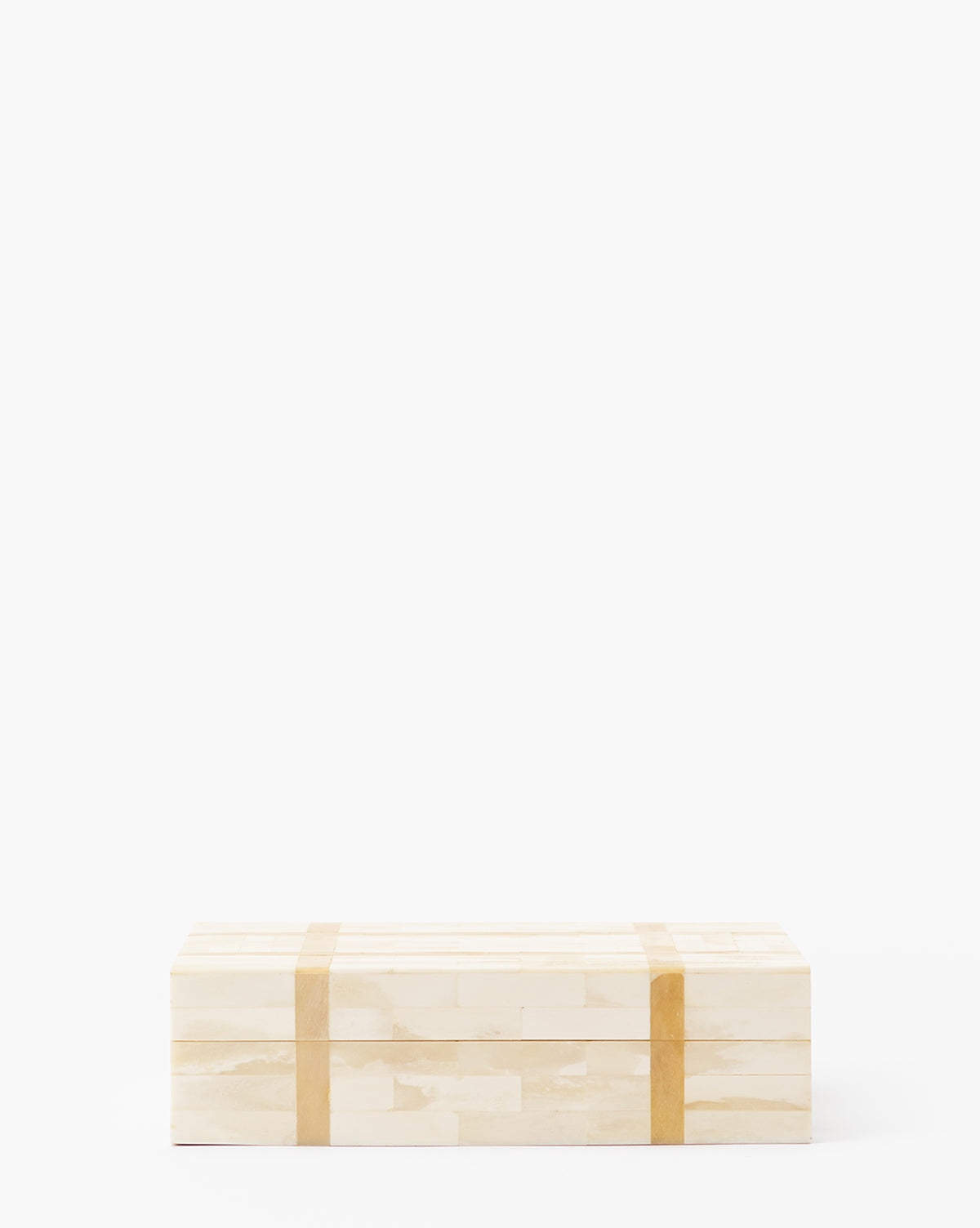 The Paige Bone Box is a rectangular light wood box with two vertical tan bands, crafted from organic materials. Its minimalist design is perfect for small storage on any modern white surface.