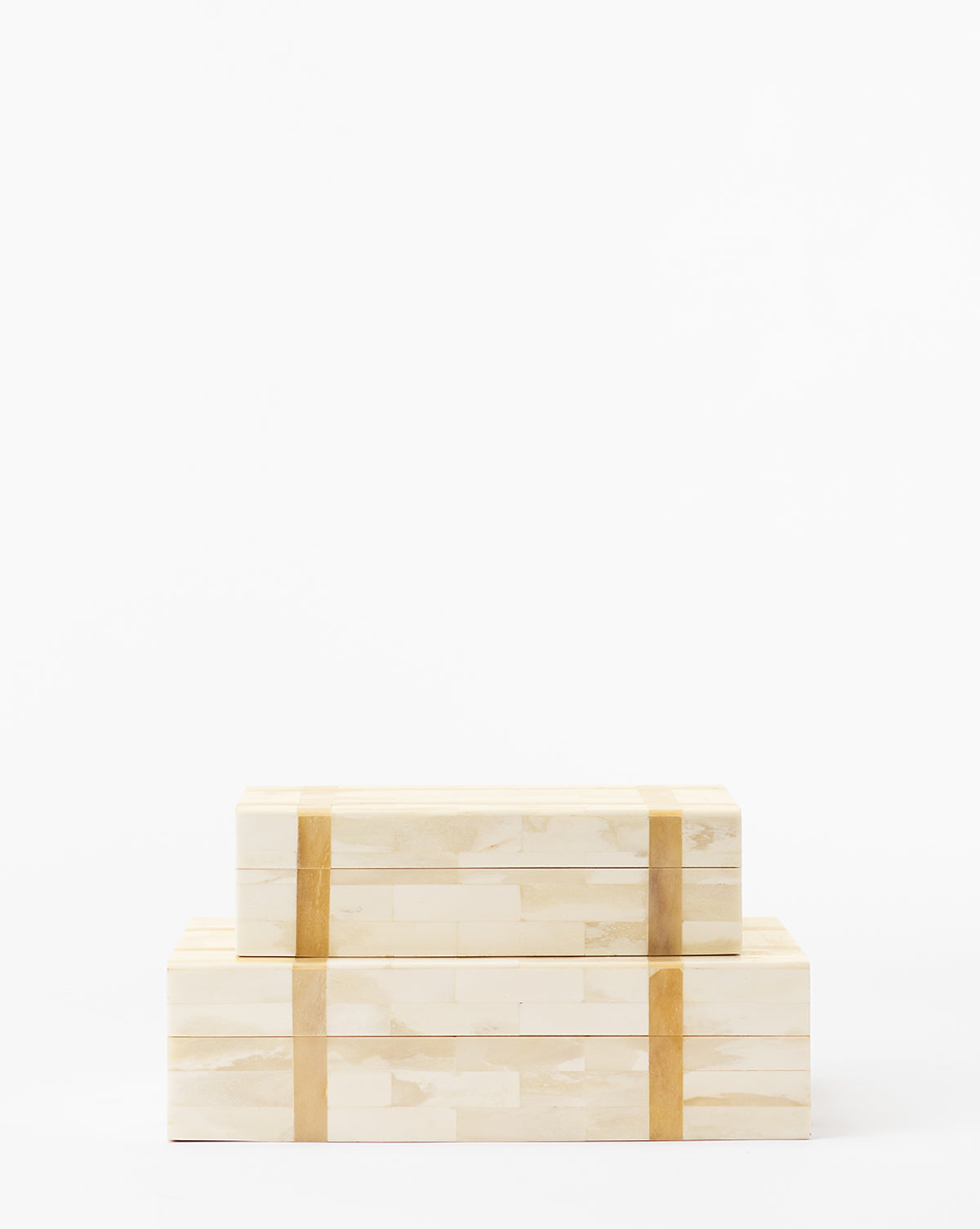 Two Paige Bone Boxes, crafted from light-colored organic materials with a vertical dark strip, are stacked neatly one atop the other against a plain white background.