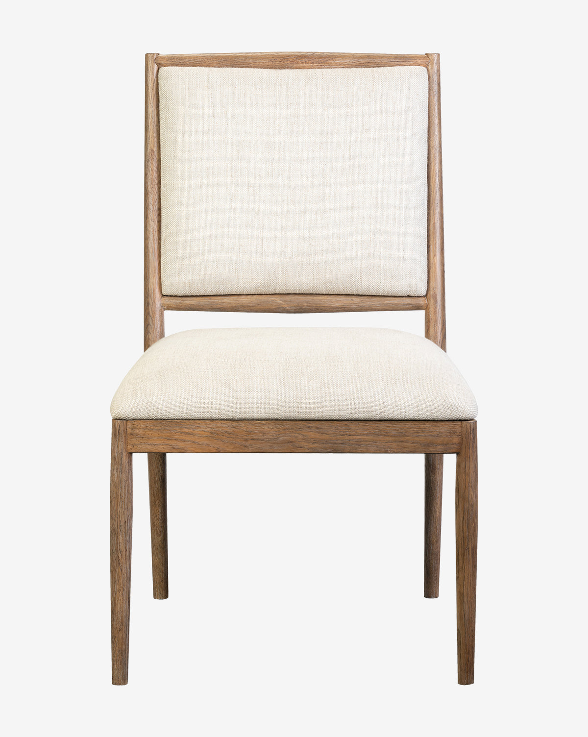 The Gomez Dining Chair has a solid oak frame, light beige cushioned seat and backrest, straight legs, and a simple modern look, shown against a white background by McGee & Co.