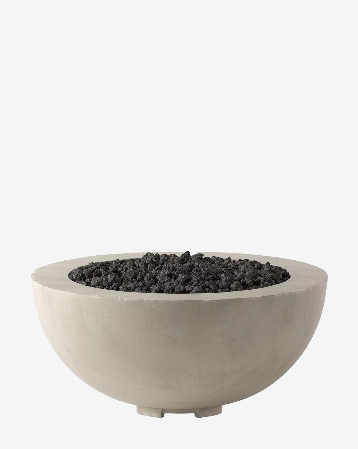 The Gordon Outdoor Fire Table is a round, modern concrete fire table filled with black lava rocks, displayed against a plain white background by McGee & Co.