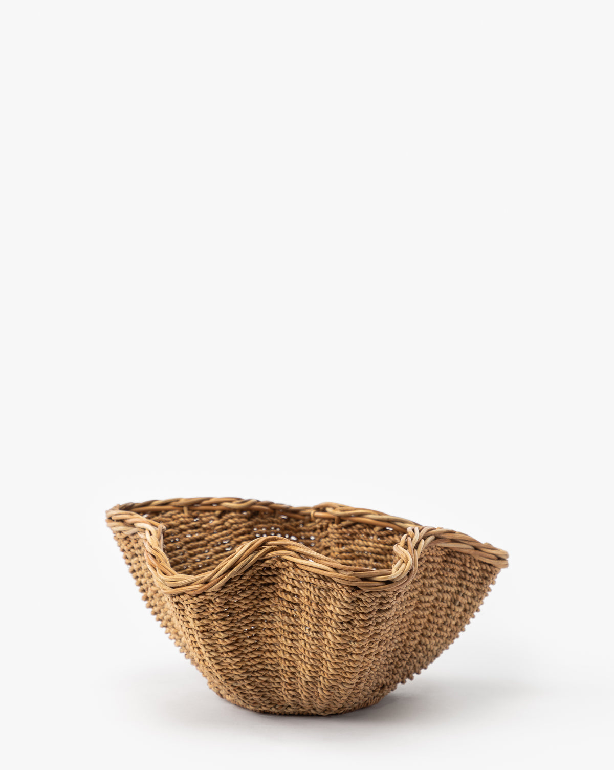 The Goulding Woven Bowl features a round wicker design and wavy, uneven rim, adding rustic charm—ideal for entryway decor when displayed against a plain white background, by McGee & Co.