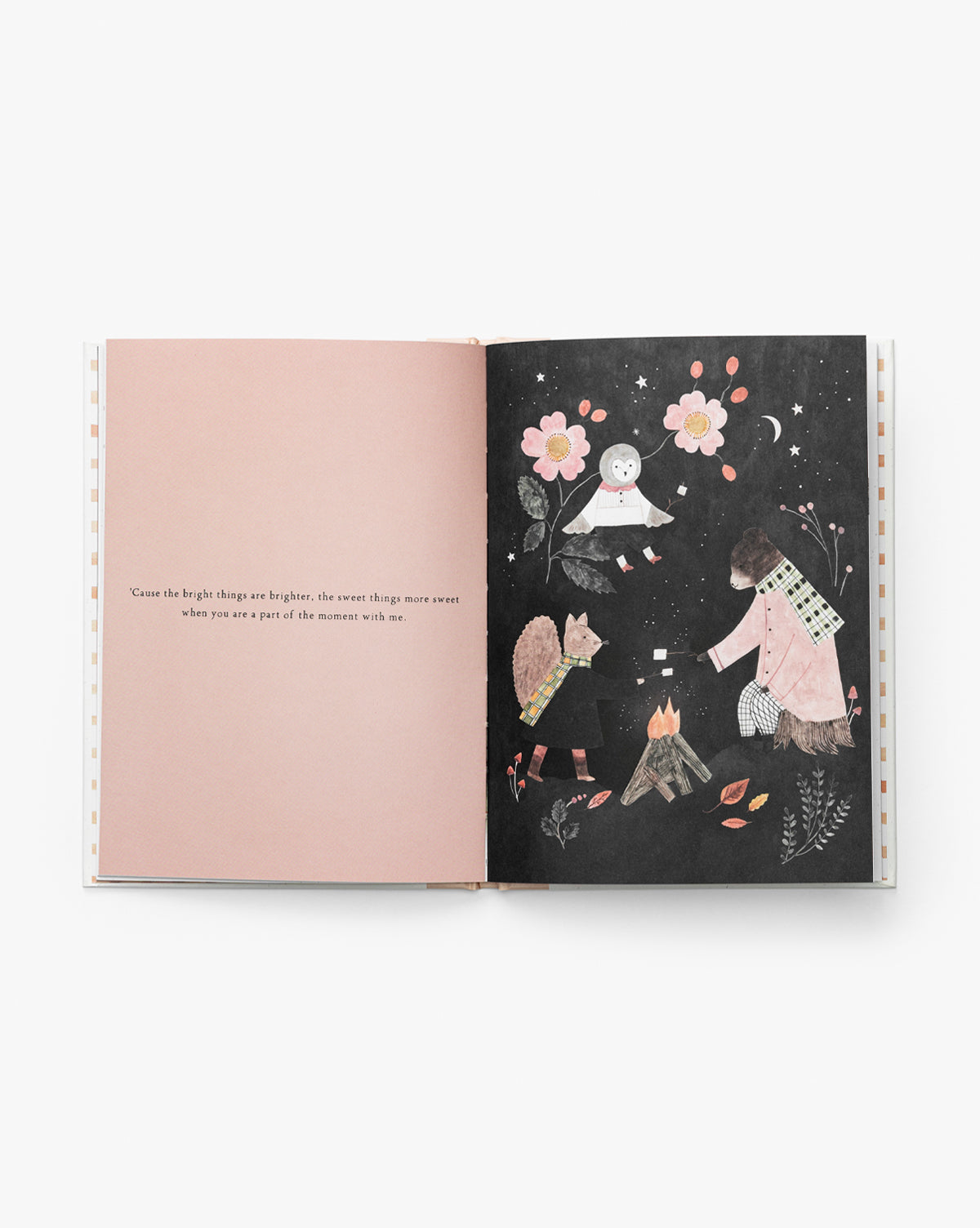 In Grateful for You, an open book reveals poetic writing on a pale pink left page, while the right page features three animals and a child gathered by a campfire at night, surrounded by flowers and stars by McGee & Co.