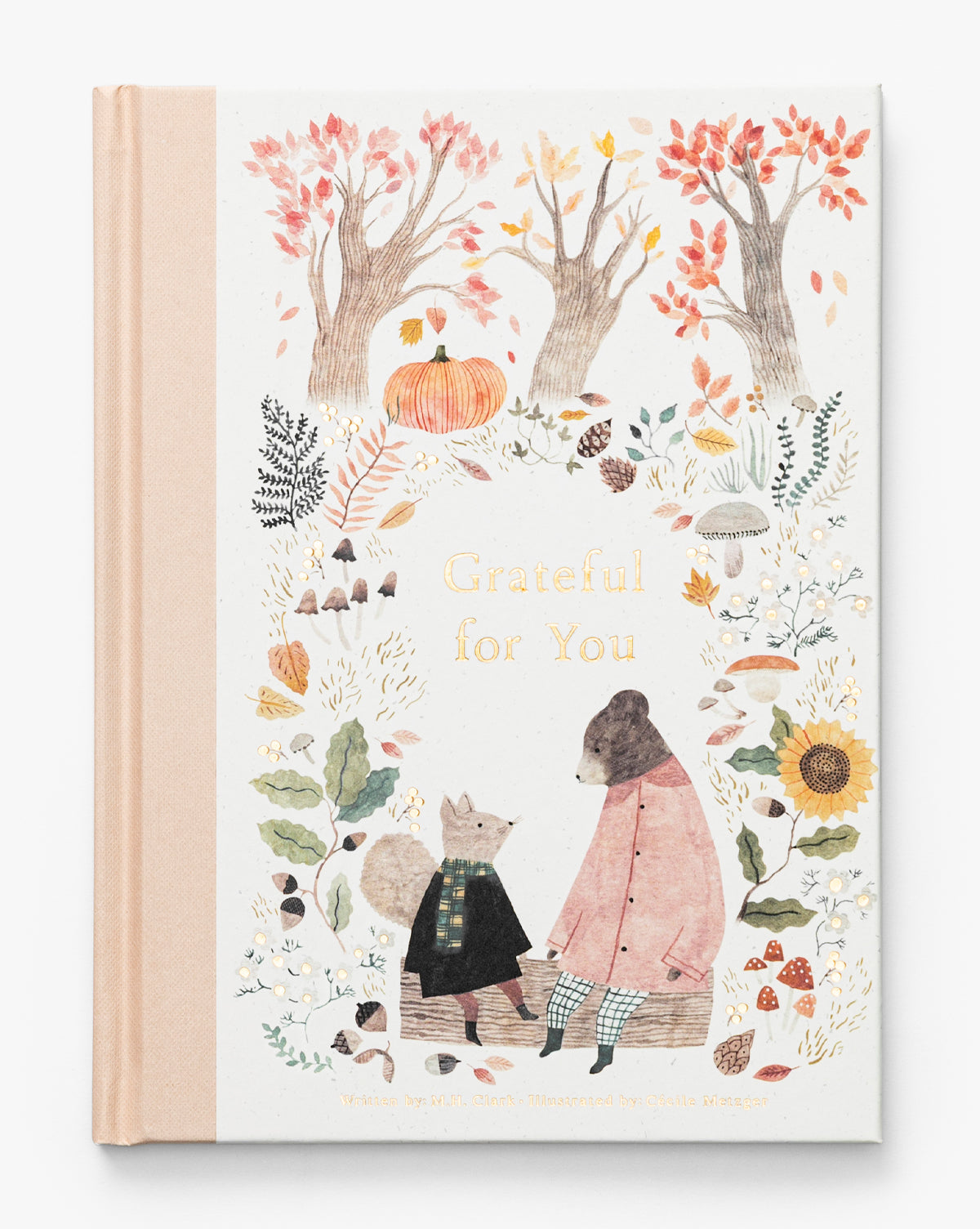 Grateful for You book cover features illustrated autumn trees, a pumpkin, leaves, flowers, and two animals—a bear in a coat and a fox in a plaid dress—sitting on a log. A thoughtful gift for someone special, by McGee & Co.