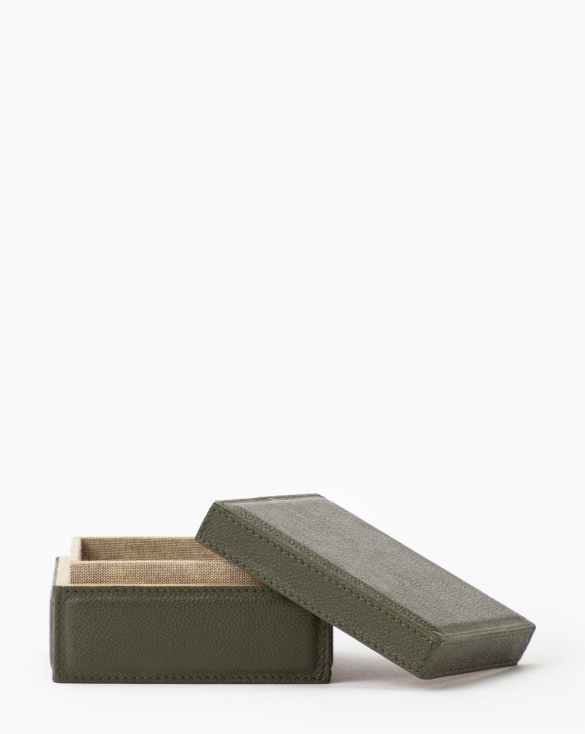 The Green Leather Box is a small, rectangular storage box made from green full grain leather with a textured finish and a tan fabric-lined interior, shown partially open against a plain white background.