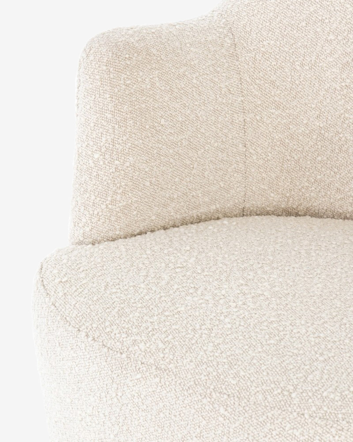 Close-up of the Gulliver Swivel Chair in textured off-white boucle, highlighting its rounded seat and curved backrest, set against a light background.