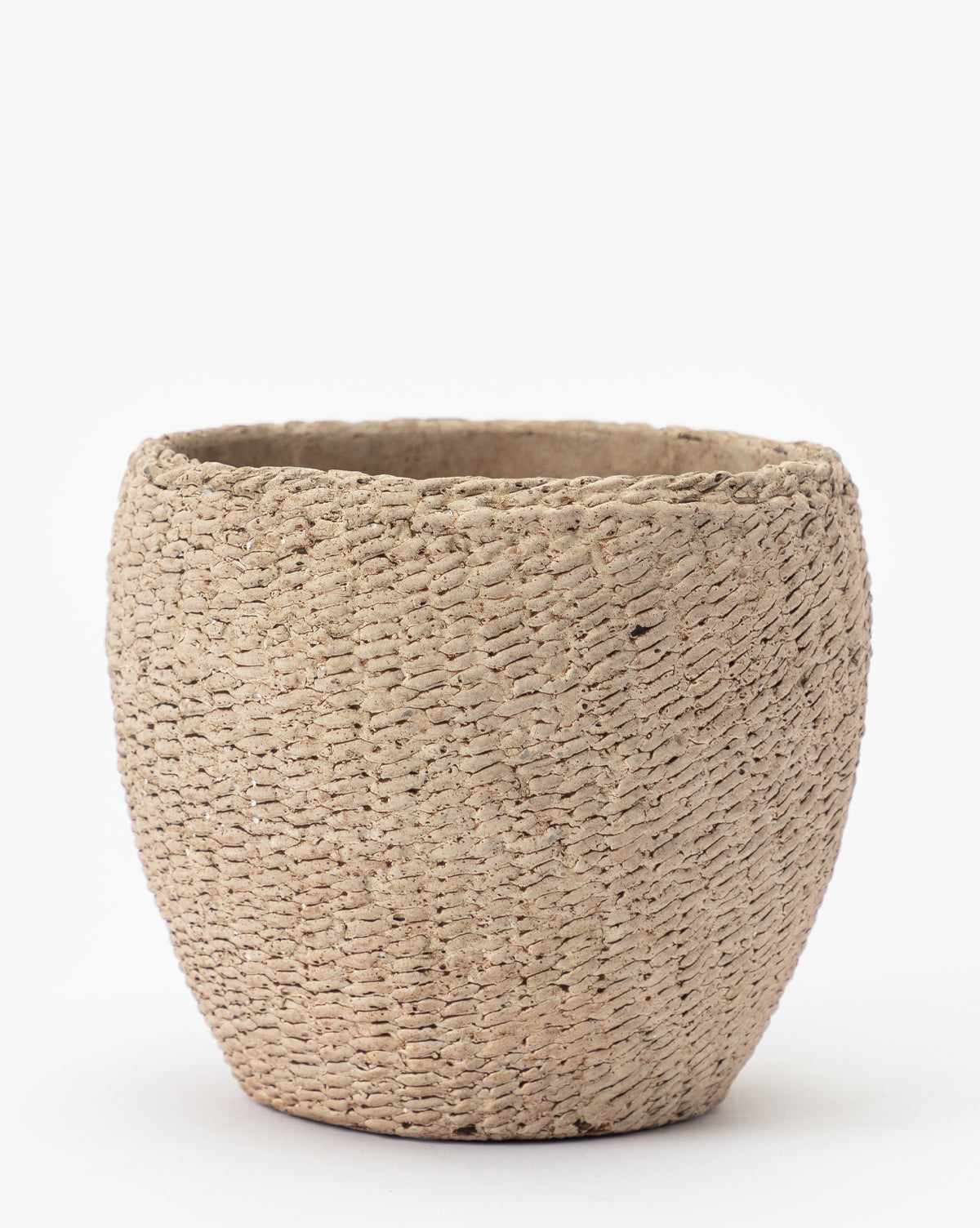 The Halston Cement Planter is a beige, watertight planter with a wide opening, rounded shape, and an irregular woven-texture surface, displayed against a plain white background.