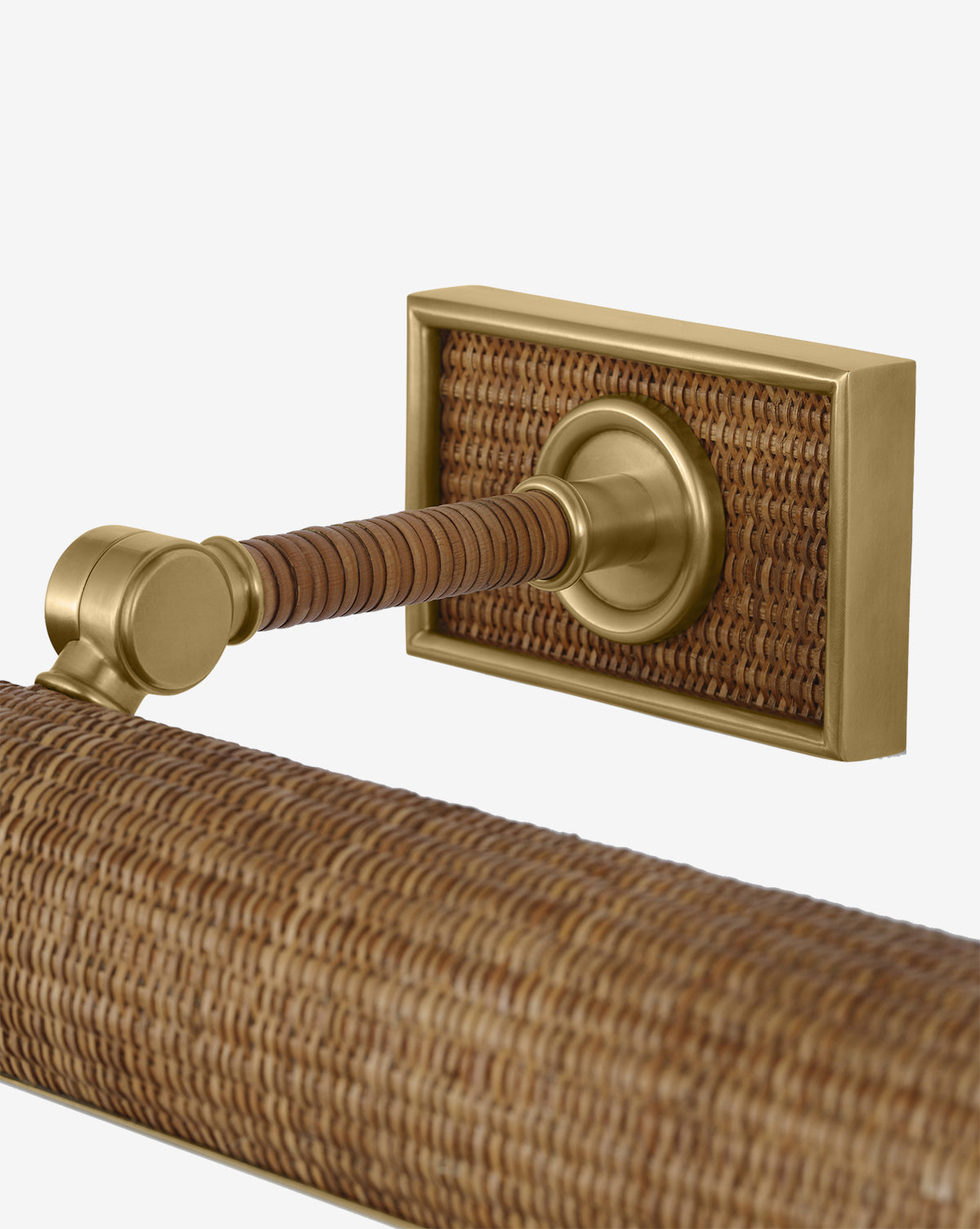 A close-up of the Halwell Picture Light, featuring a brushed brass mount and woven rattan accents on the bar and wall plate, set against a plain white background, by McGee & Co.