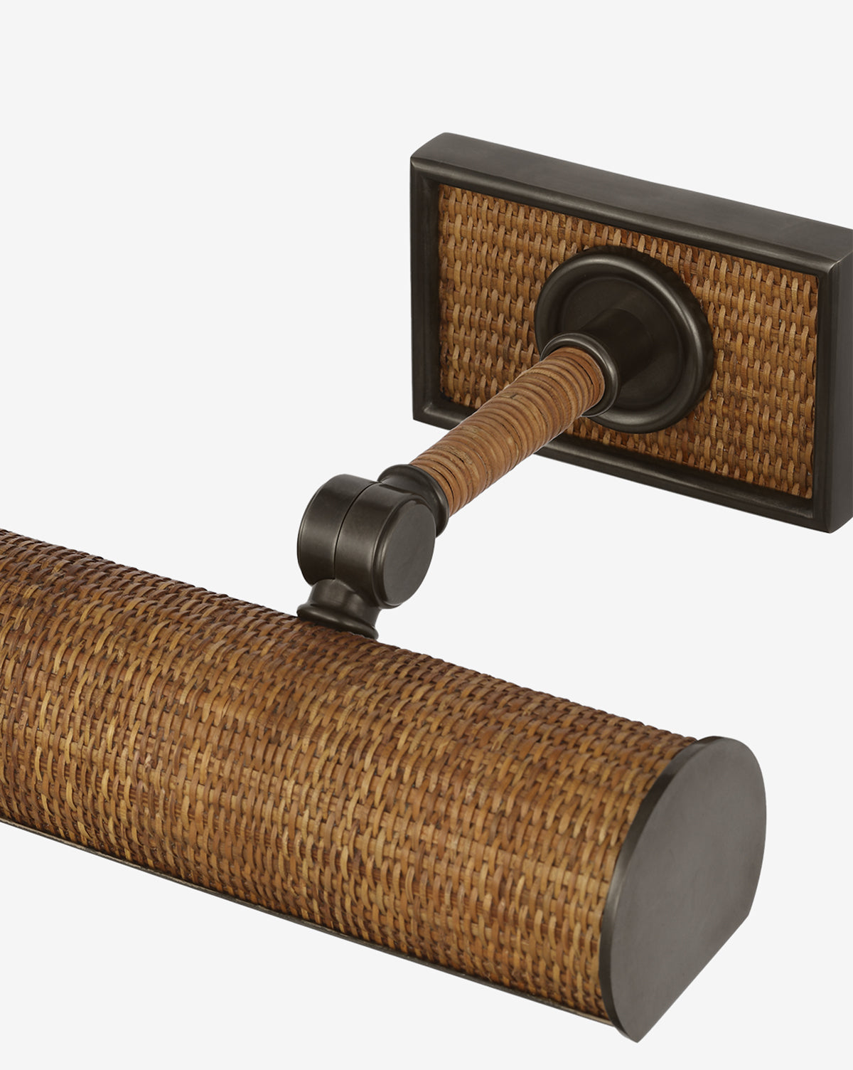 A close-up of the Halwell Picture Light, a wall-mounted fixture with a rectangular base and cylindrical rattan-textured shade accented by dark metal—ideal for illuminating elegant artwork, by McGee & Co.