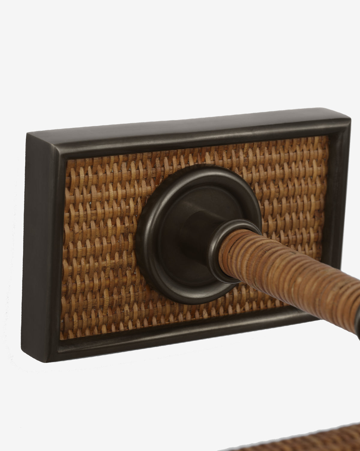 Close-up of the Halwell Picture Light: a door handle with a rectangular backplate featuring woven rattan and a dark metal border, attached to a rod in matching material—ideal for rooms enhanced by thoughtful artwork lighting, by McGee & Co.