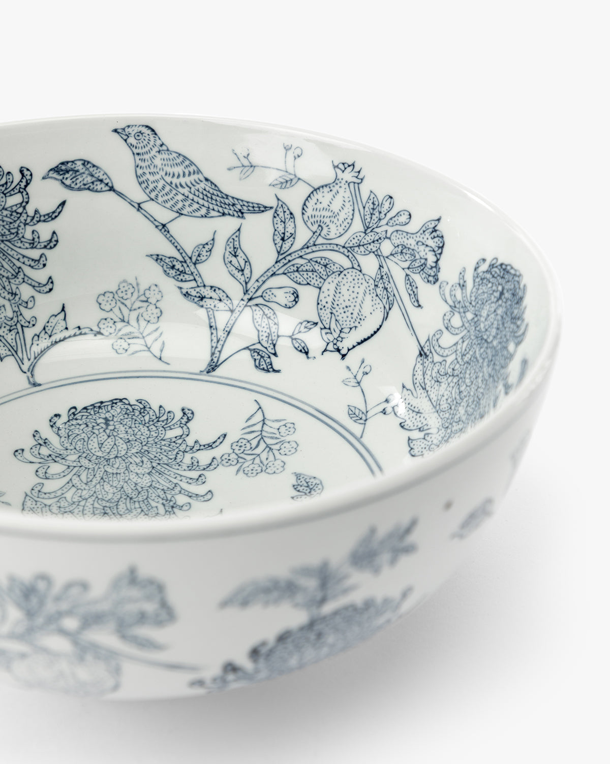 The Hand Stamped Botanical Bowl is a white stoneware bowl with detailed blue bird and floral designs on the inner surface, shown against a plain white background, by McGee & Co.