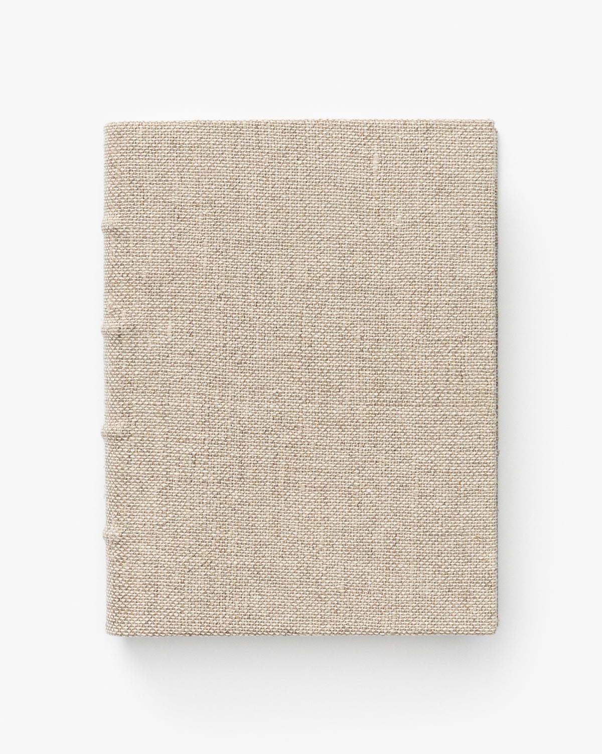 The Handcrafted Linen Book features a closed, square design with a textured beige fabric cover, shown from above on a plain white background.