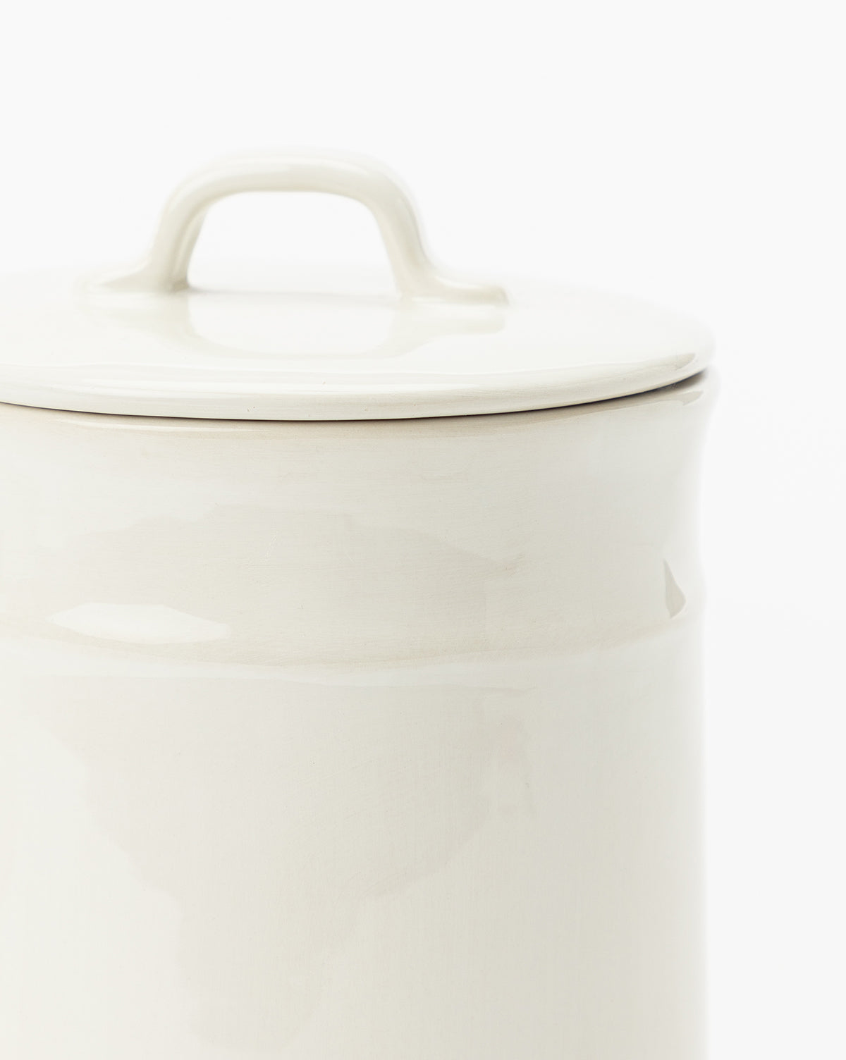 A close-up of the Handled Ceramic Canister with matching lid highlights its elegant, modern design—ideal for kitchen storage—set against a plain white background.