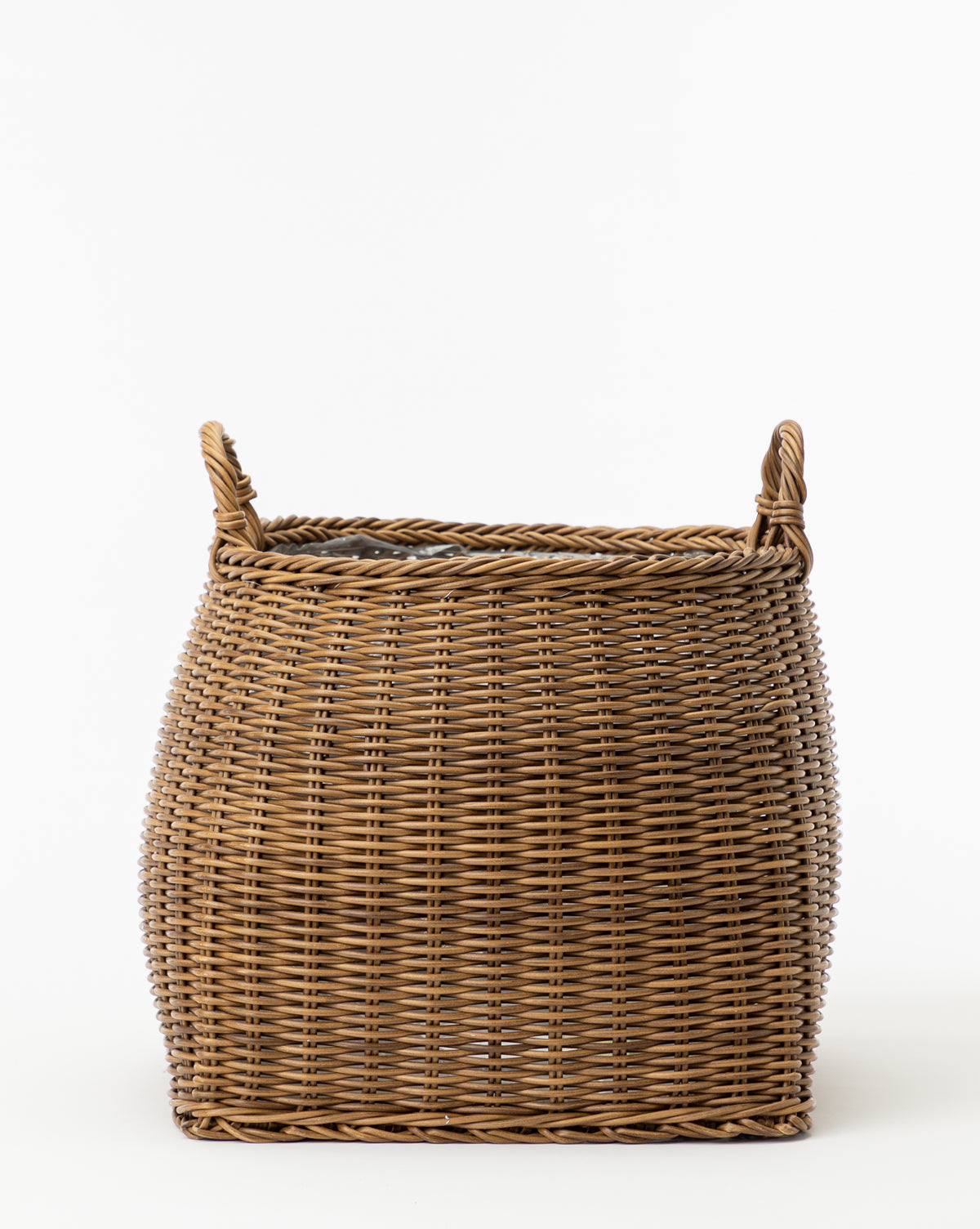 The Handled Planter Basket, a rectangular poly-rattan basket with two loop handles on each side, is ideal for showcasing indoor plants and is pictured against a plain white background.