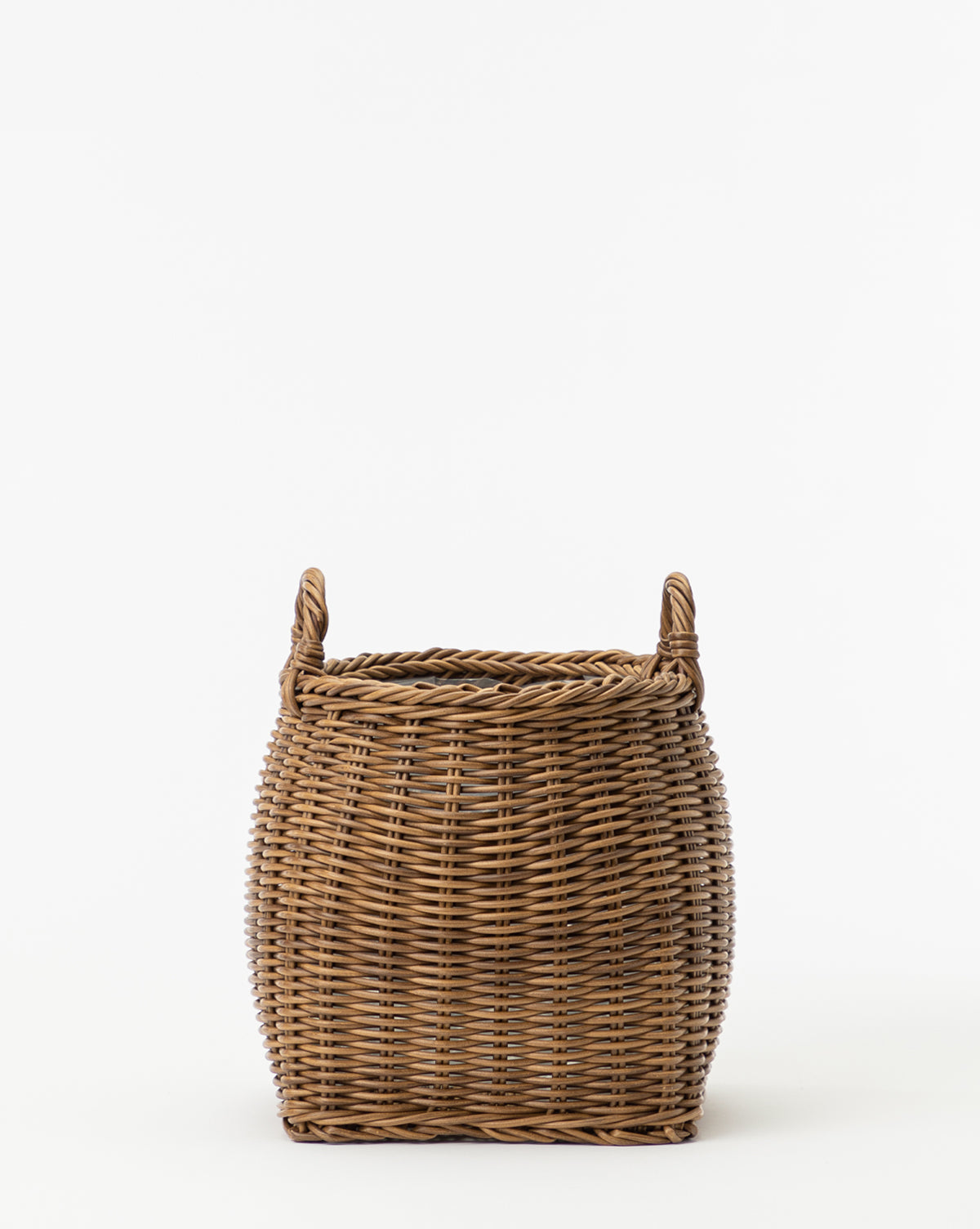 The Handled Planter Basket is a medium-sized, brown woven poly-rattan planter with two opposite handles, ideal for showcasing indoor plants against a plain white background.