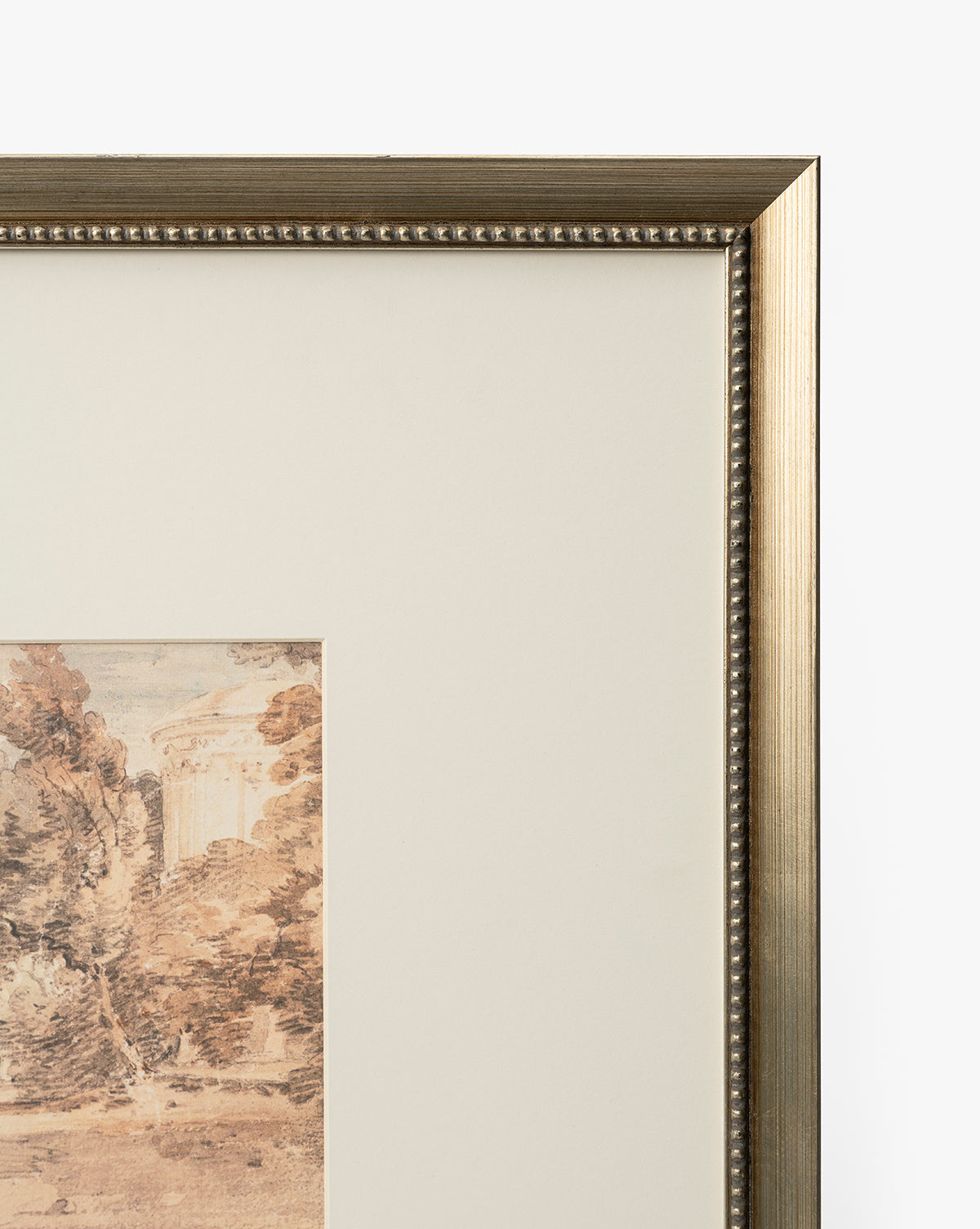 A close-up of the Harewood Park artwork shows its distressed silver wood frame with beaded detailing and a partially visible sepia-toned landscape giclee print inside, focusing on the top right corner, by McGee & Co.