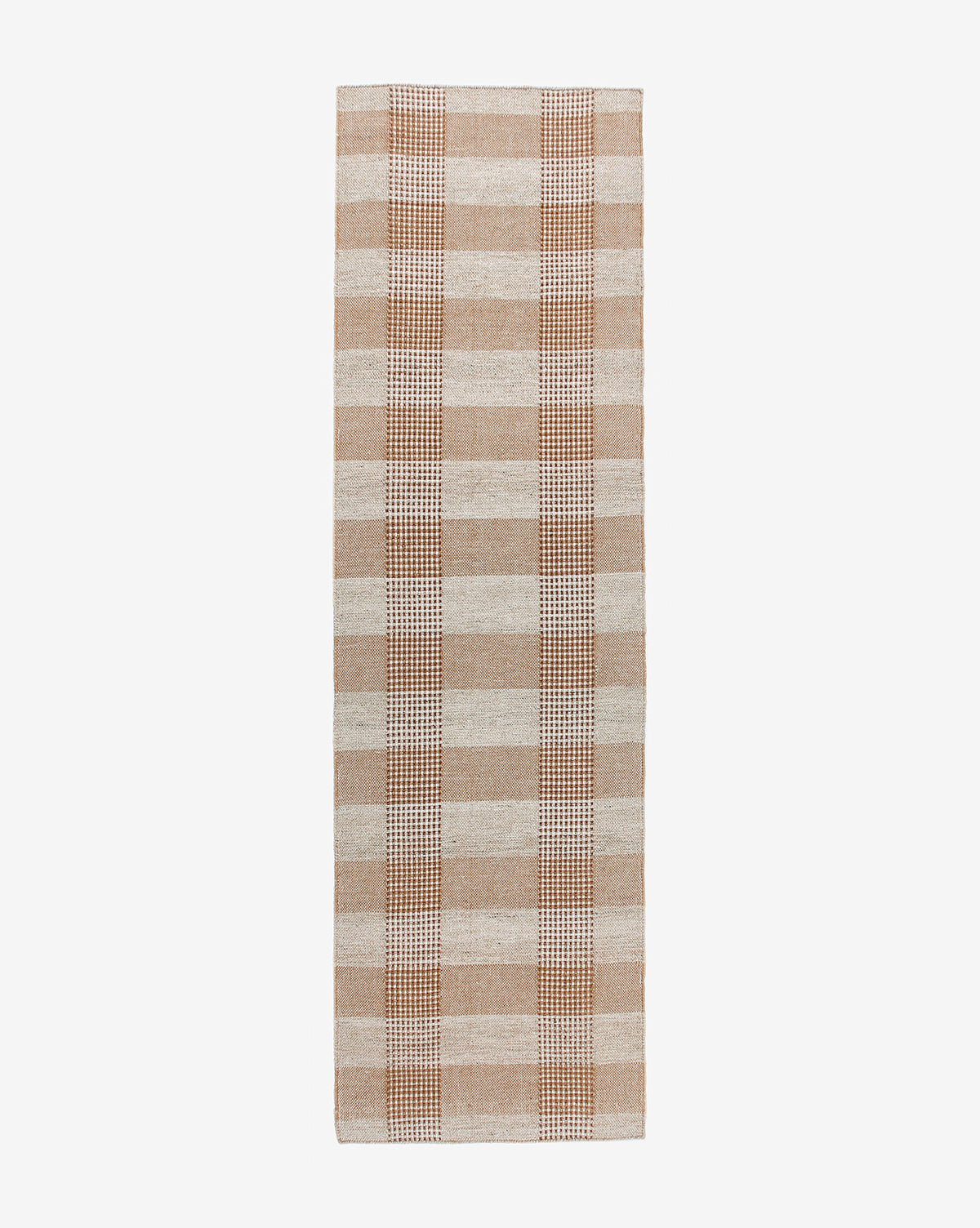 The Hargrove Handwoven Indoor/Outdoor Rug features a beige and tan plaid checker pattern with alternating wide and narrow stripes on a white background.