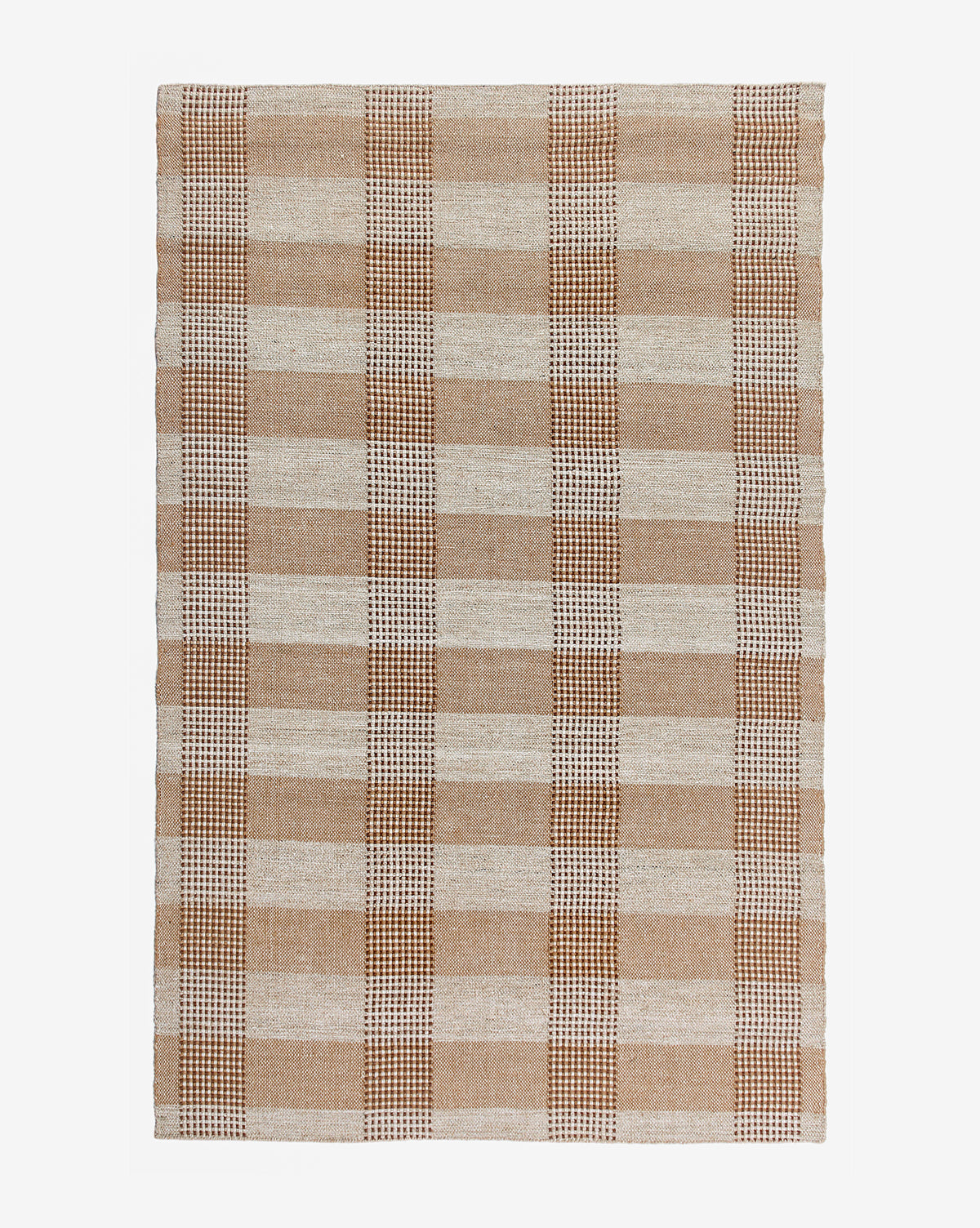 The Hargrove Handwoven Indoor/Outdoor Rug features a rectangular plaid checker pattern in tan, brown, and cream, with large alternating squares and lines. Made from durable PET fibers, it’s shown photographed on a white background.