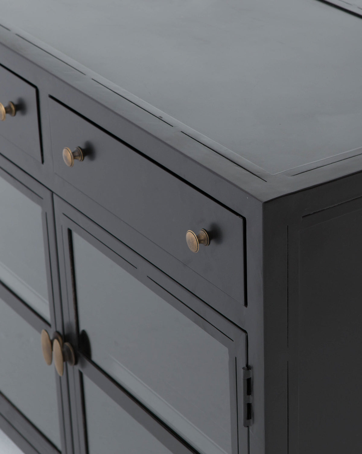 Close-up view of the Harry Sideboard in dark gray, featuring gold round knobs on its drawers and doors, showcasing a simple, modern design with clean lines.