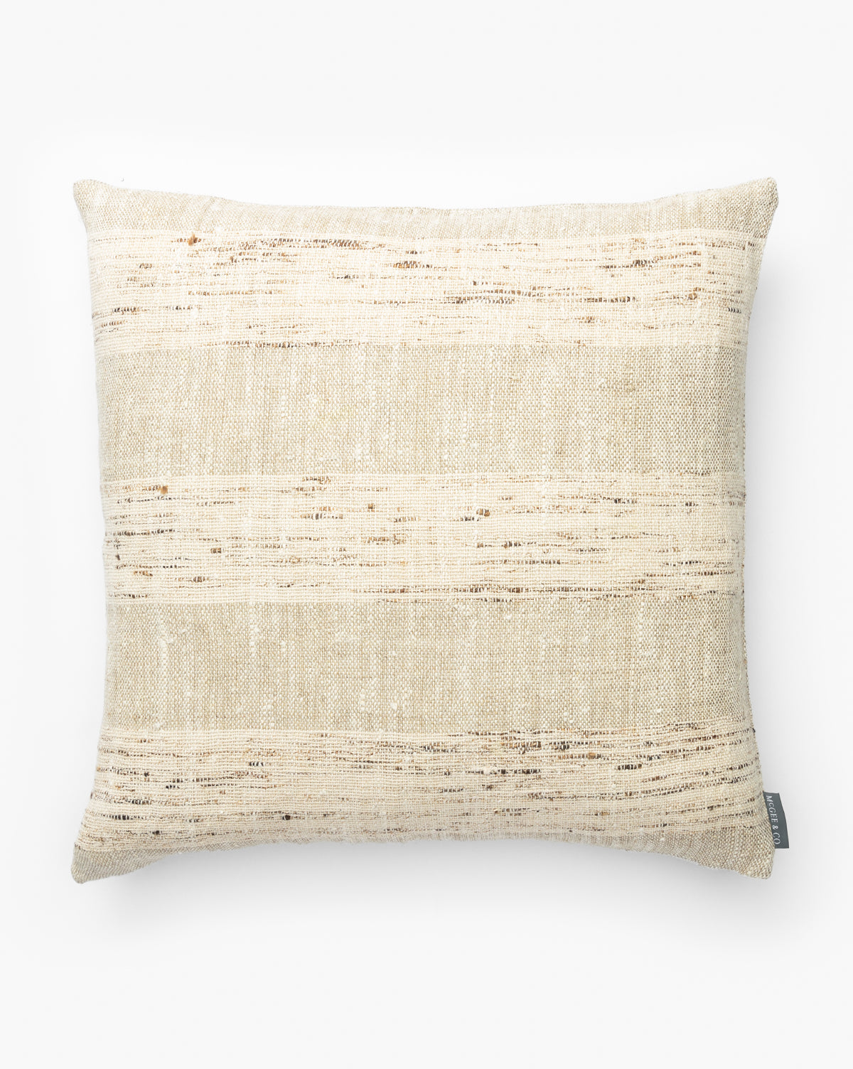 The Havens Pillow Cover, shown on a white background, features a square shape in tan, brown, and cream with subtle horizontal textured stripes and a woven fabric pattern for a sophisticated look, by McGee & Co.