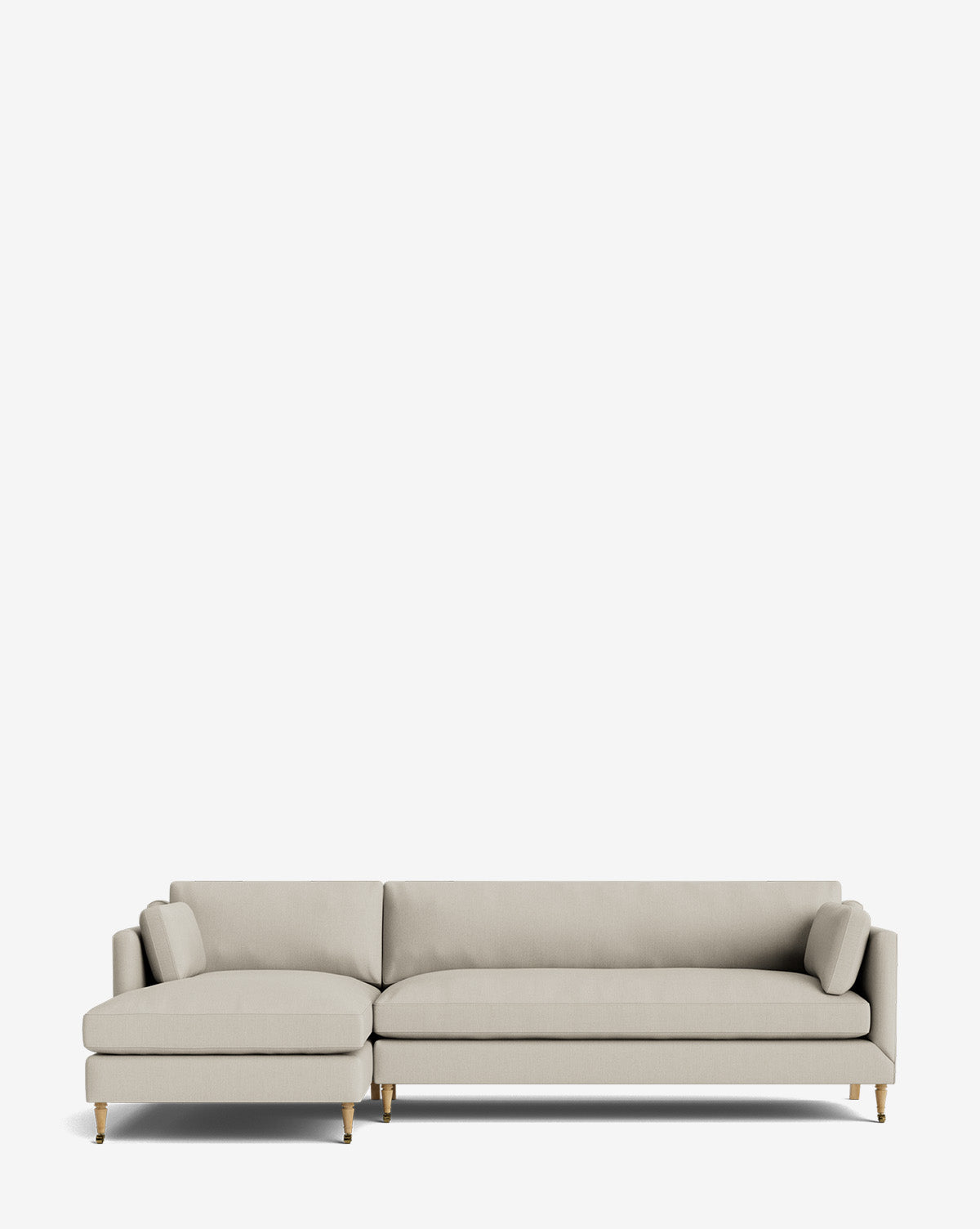 The Haverford Upholstered Left Chaise Sectional 113 features light gray fabric, gold-capped wooden legs, a low back, and two matching bolster pillows, shown against a plain white background by McGee & Co.