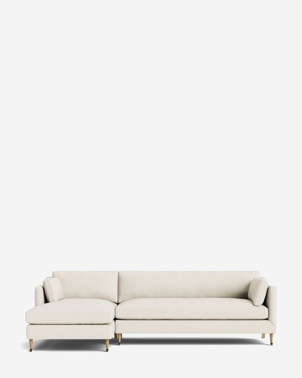 The Haverford Upholstered Left Chaise Sectional features slim cushions and gold-tipped wooden legs in light beige upholstery, shown against a plain white background by McGee & Co.