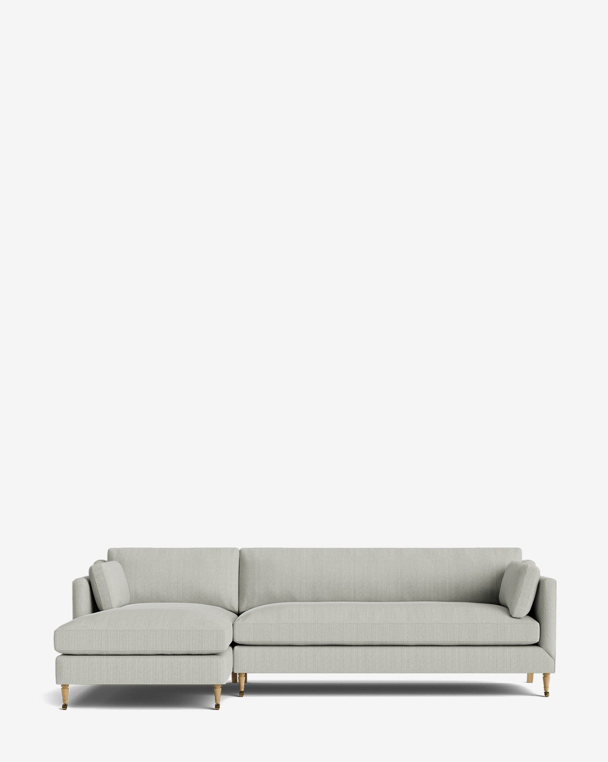 The Haverford Upholstered Left Chaise Sectional 113 is a modern, customizable light gray sofa featuring slim armrests, two cylindrical pillows, and wooden legs with gold accents, shown against a plain white background by McGee & Co.