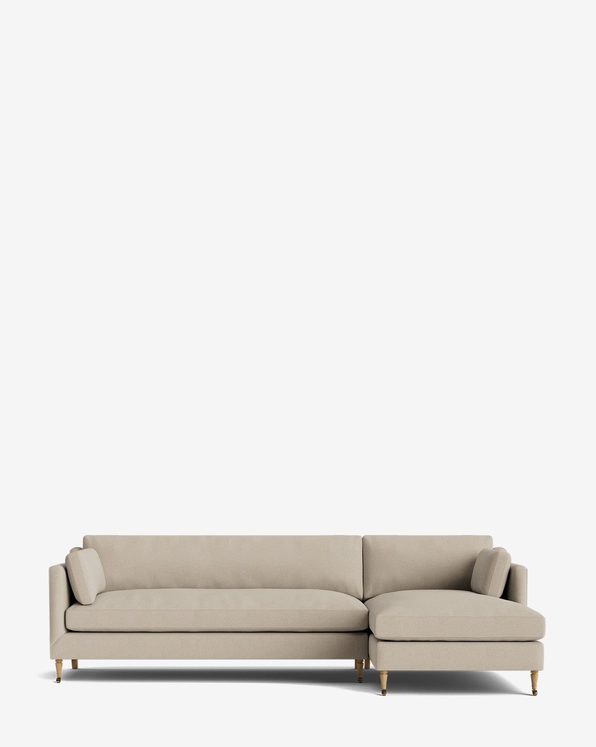 The Haverford Upholstered Right Chaise Sectional 113 in light beige features slim arms, angled wooden legs, two bolster pillows, and a right-side chaise lounge—an elegant made-to-order piece set against a plain white background by McGee & Co.