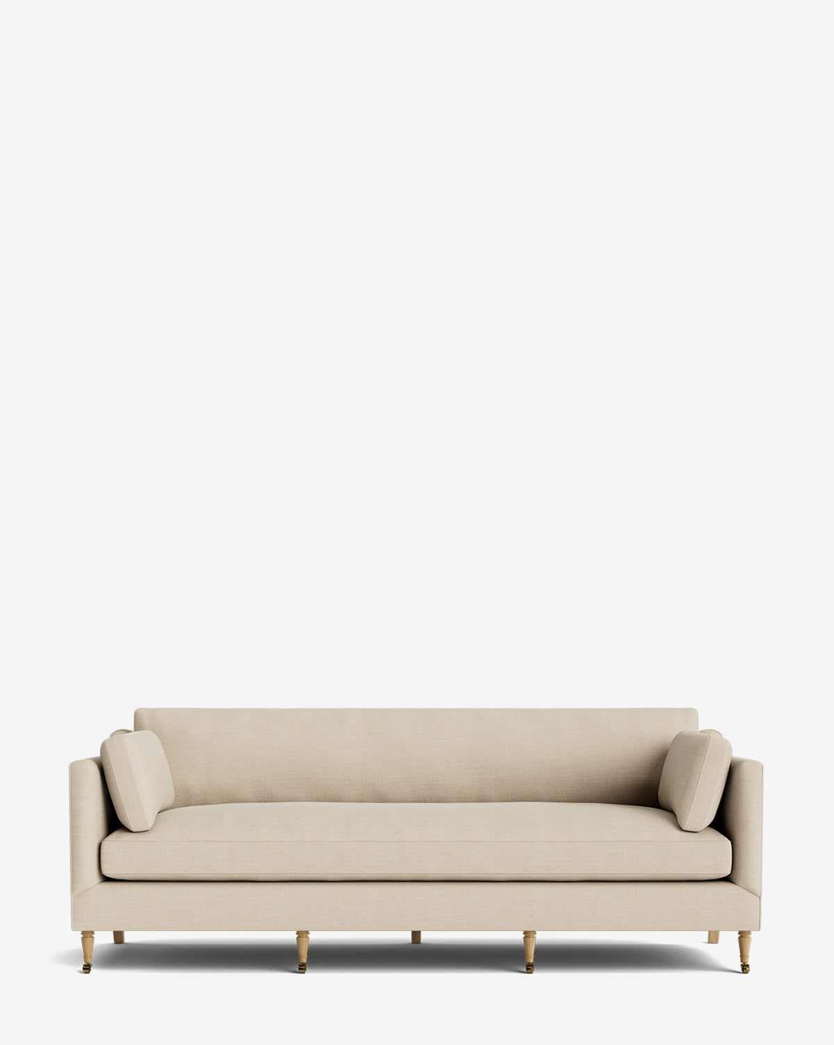 The Haverford Upholstered Sofa 90 is a modern, handcrafted beige sofa with straight lines, two cylindrical bolster pillows, and six wooden legs featuring gold accents, displayed against a plain white background by McGee & Co.