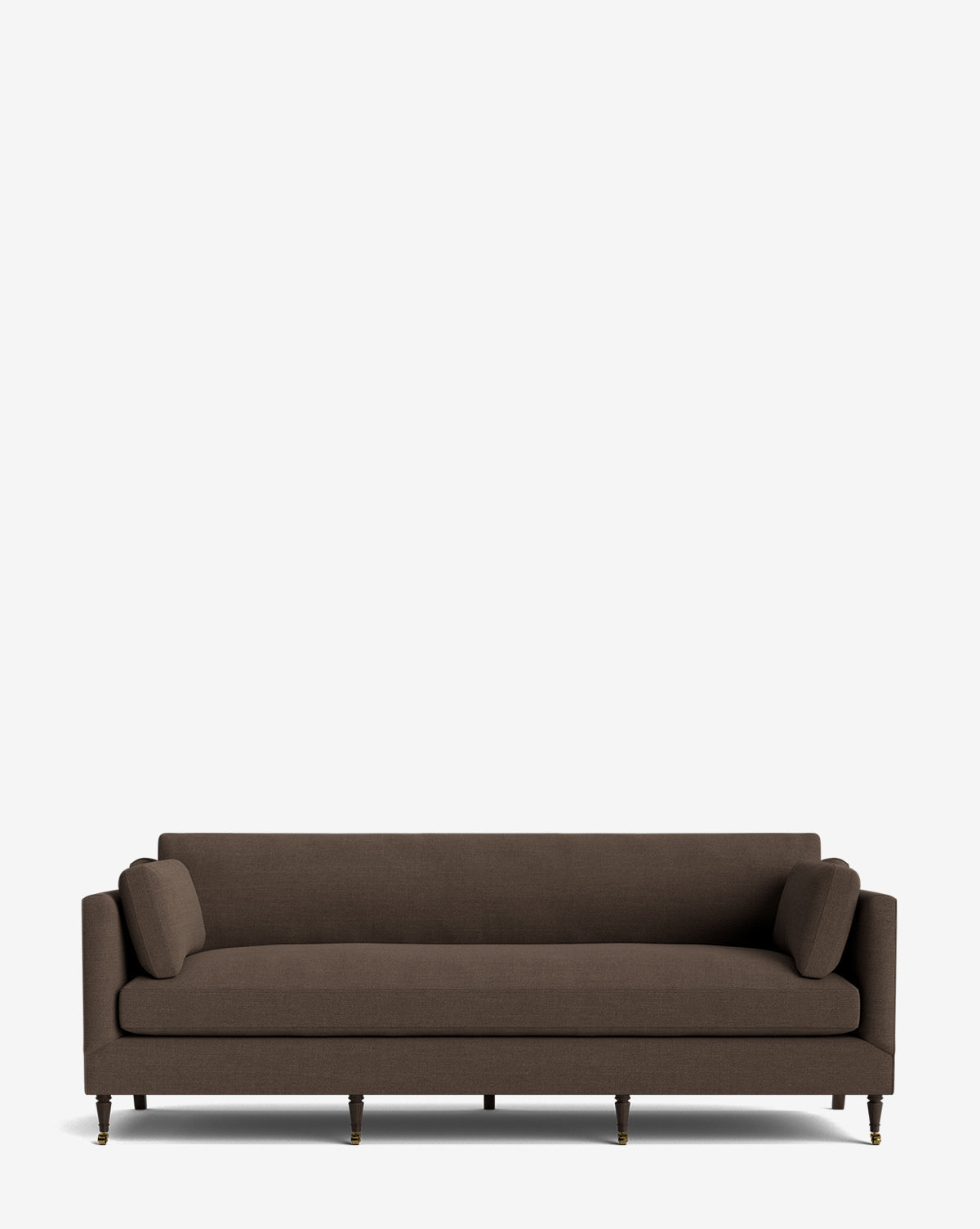 A dark brown, modern Haverford Upholstered Sofa 90 with straight arms, two matching bolster pillows, and wooden legs with metal casters is set against a plain white background, by McGee & Co.