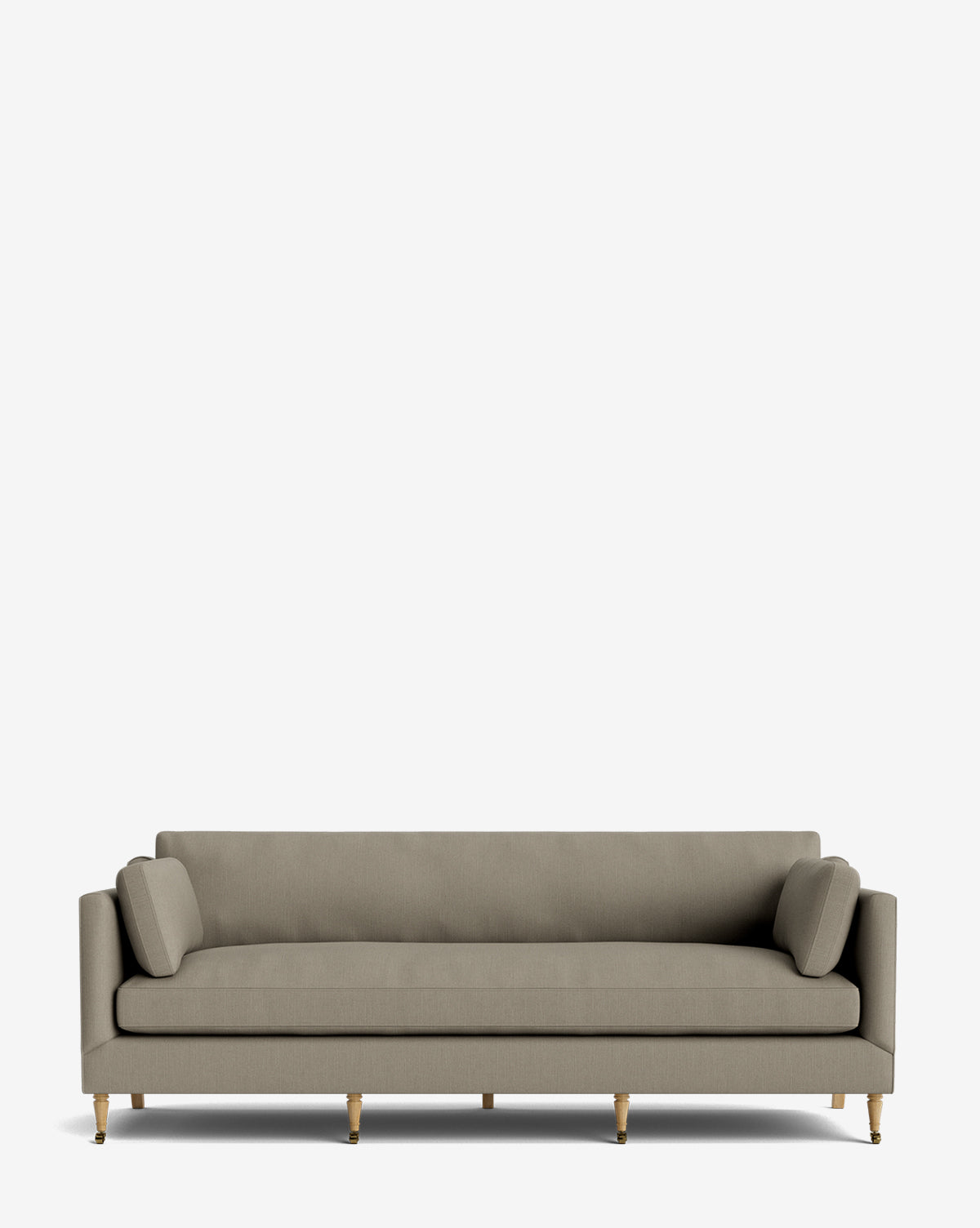 The Haverford Upholstered Sofa 90 is a modern, light grey handcrafted sofa with two cylindrical side cushions, straight armrests, and wooden legs with gold tips, shown on a plain white background by McGee & Co.