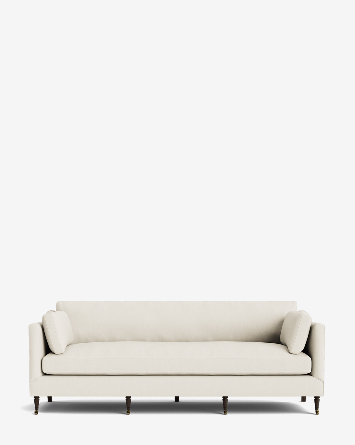 The Haverford Upholstered Sofa 90 is a modern cream sofa featuring low arms, two cylindrical side cushions, and six dark wood legs, shown against a plain white background by McGee & Co.