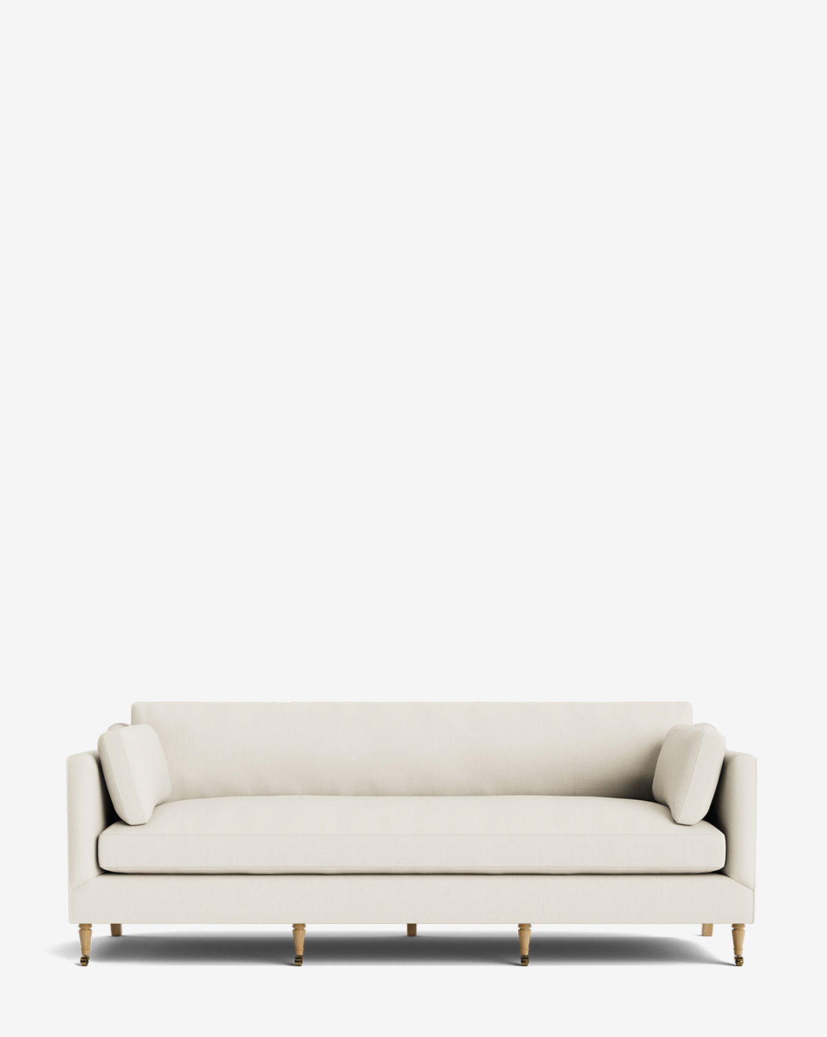 The Haverford Upholstered Sofa 90 is a modern, light beige sofa with a low back, two cylindrical side pillows, and wooden legs, shown against a plain white background by McGee & Co.