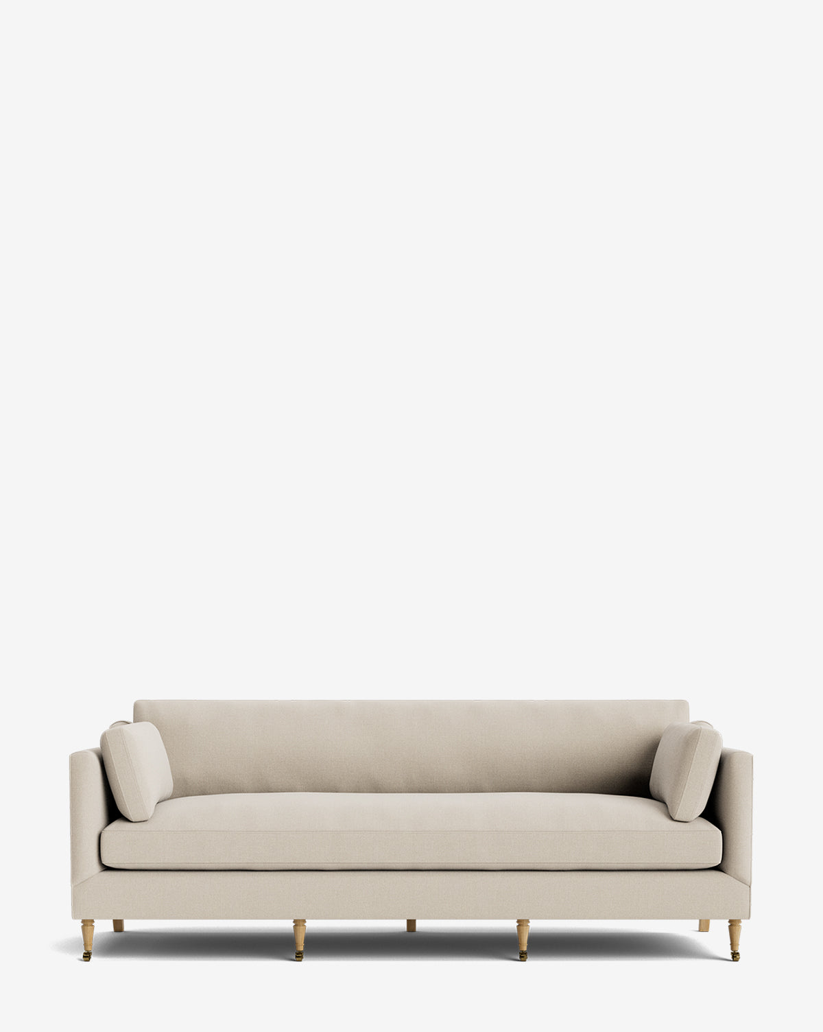 The Haverford Upholstered Sofa 90 is a modern, handcrafted beige piece with wooden legs and two cylindrical cushions, shown against a plain white background by McGee & Co.
