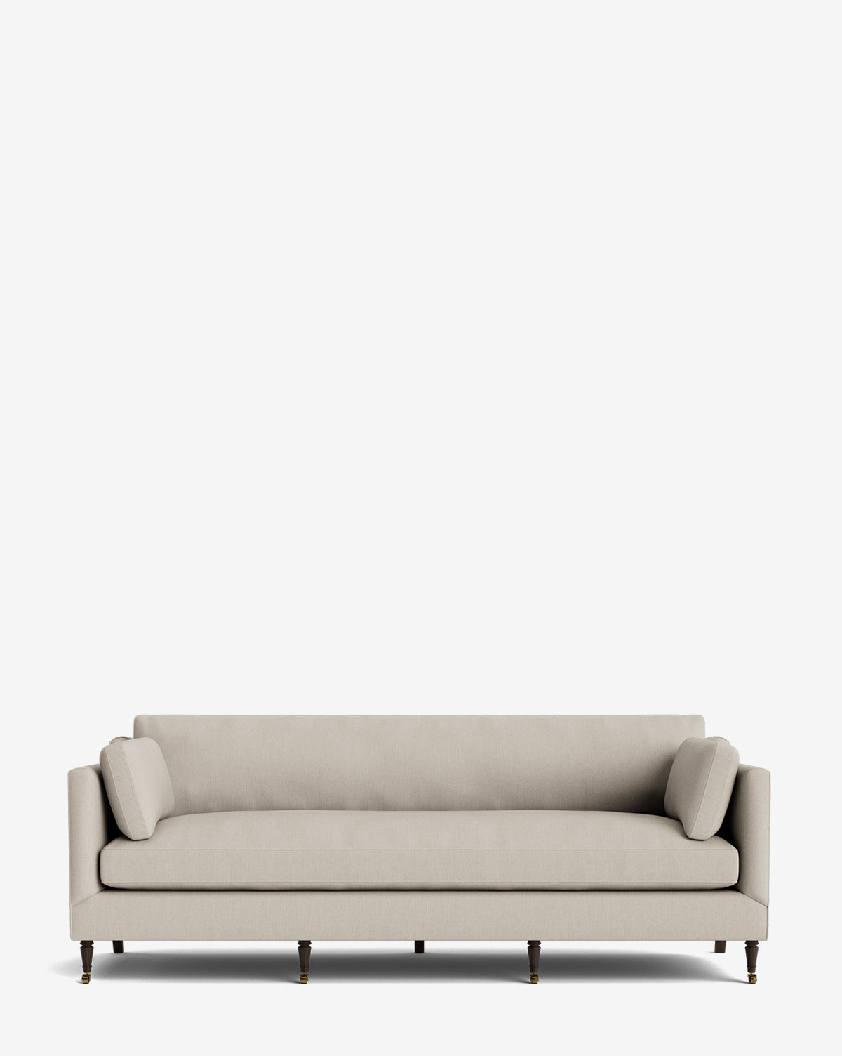 A modern, light beige Haverford Upholstered Sofa 90 with two cylindrical bolster pillows and slim wooden legs, set against a plain white background by McGee & Co.