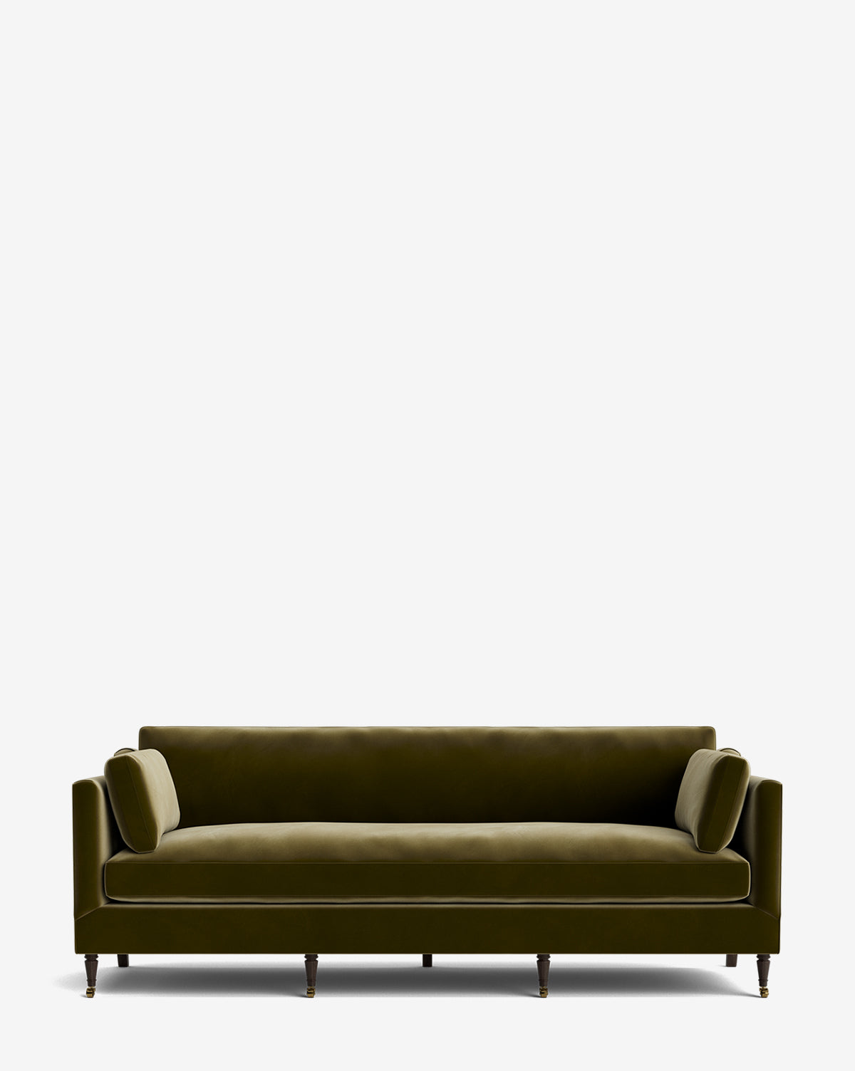The Haverford Upholstered Sofa 90 in olive green velvet features low arms, matching cylindrical bolster pillows, and dark wooden legs, set against a plain white background. This modern sofa is customizable for your space, by McGee & Co.