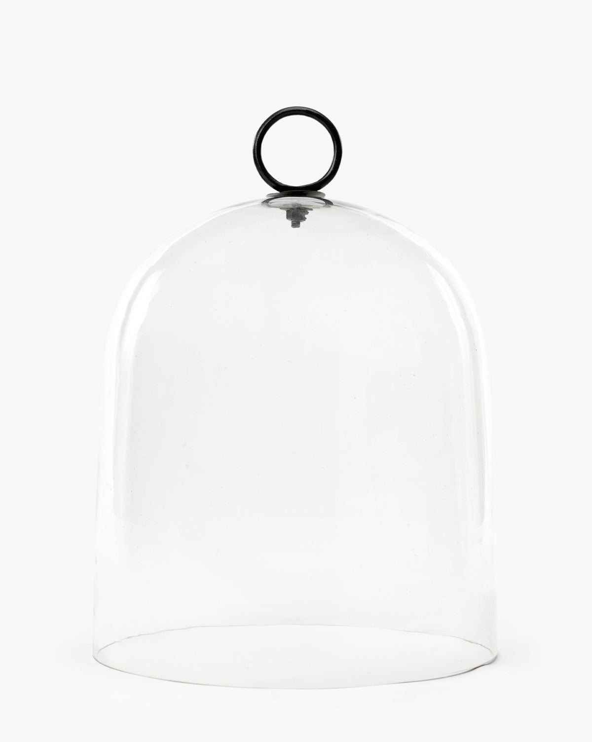 The Hazy Cloche features a clear, rounded glass dome with a black circular handle on top, displayed against a plain white background by McGee & Co.