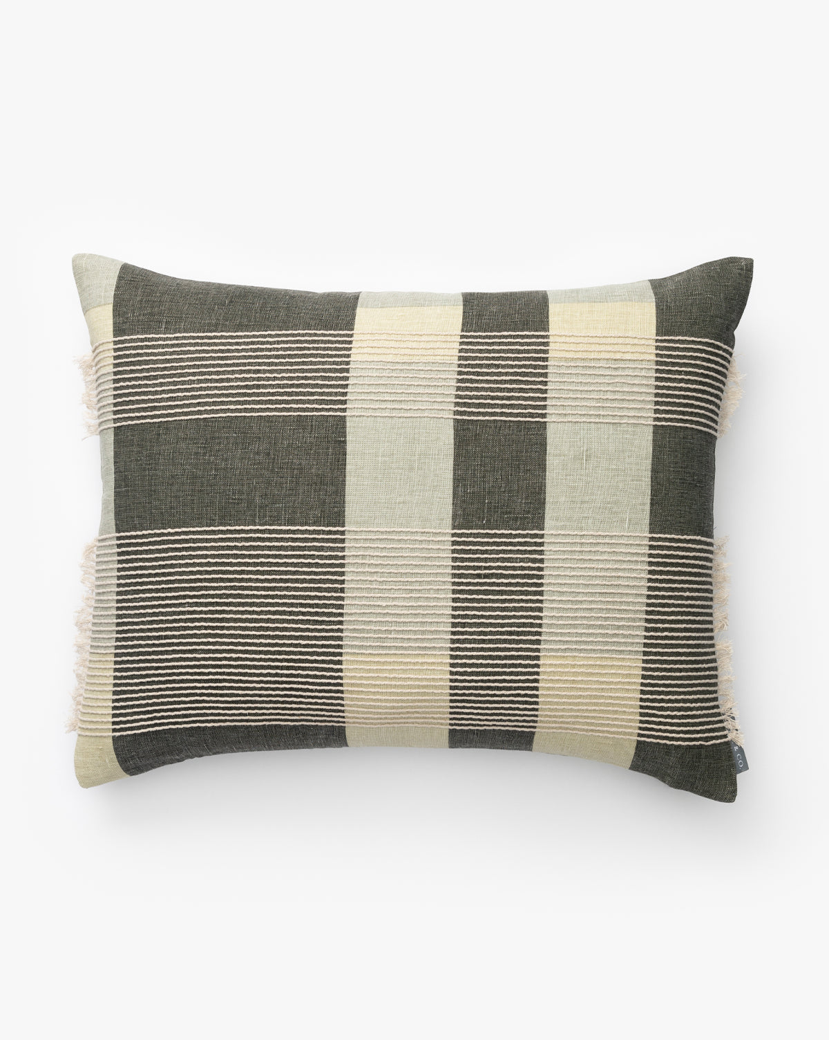 The Henderson Pillow Cover features wide black, beige, and cream stripes with horizontal stitched lines and fringed edges on the short sides, crafted from soft linen and shown on a plain white background by McGee & Co.
