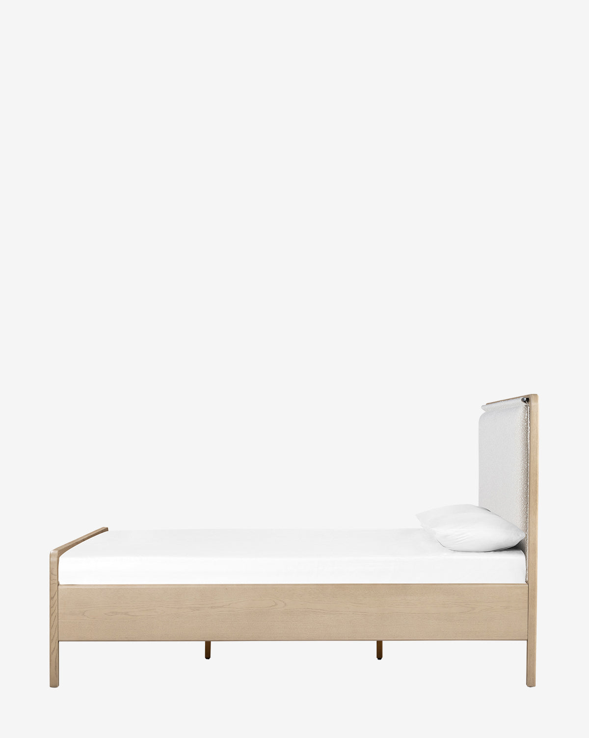The Hensley Bed features a minimalist wooden frame with a light finish, modern design, white cushioned headboard, and a white mattress topped with a single pillow, all set against a plain light gray background.