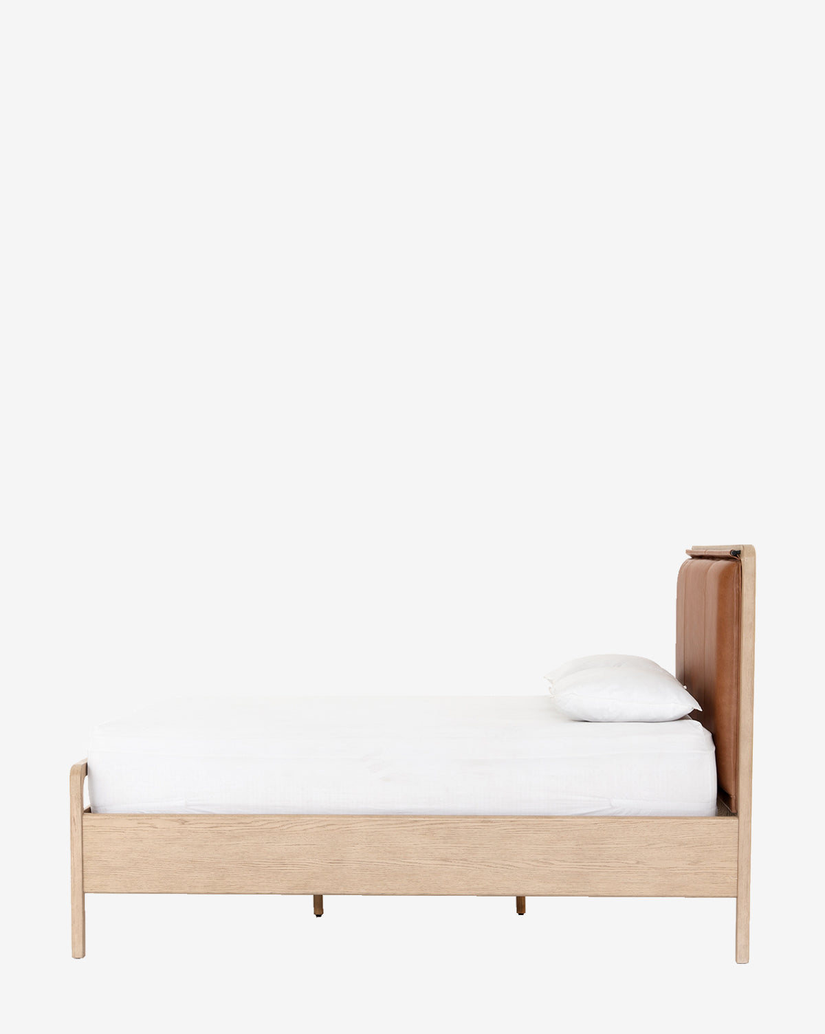 The Hensley Bed features a minimalist design with a light wood finish, white mattress and pillow, and a brown leather headboard, shown from the side against a plain white background for a modern, simple look.