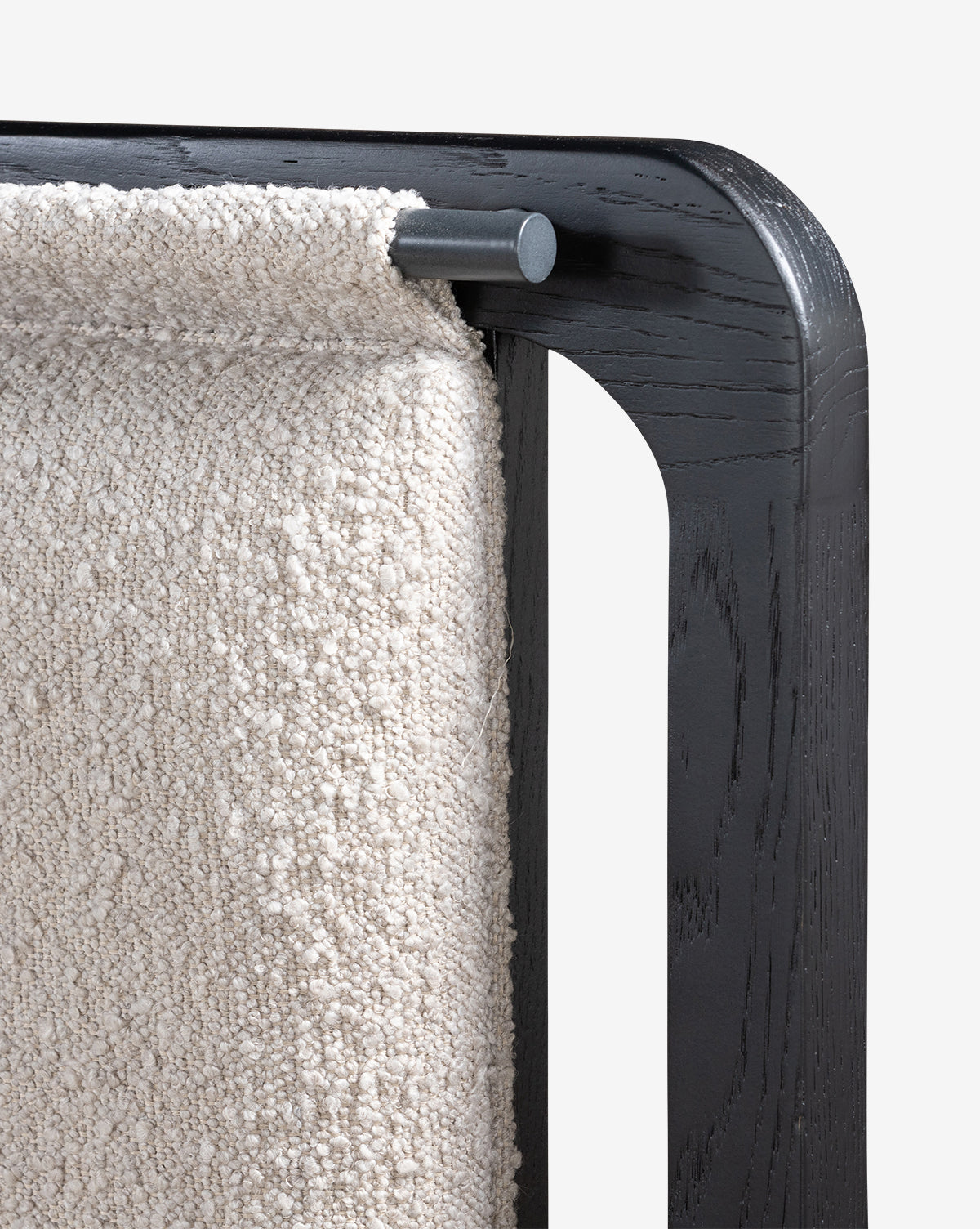 Close-up of a black wooden frame displaying a thick, textured off-white fabric draped over a metal rod—an elegant accent that pairs perfectly with the modern design of the Hensley Bed.