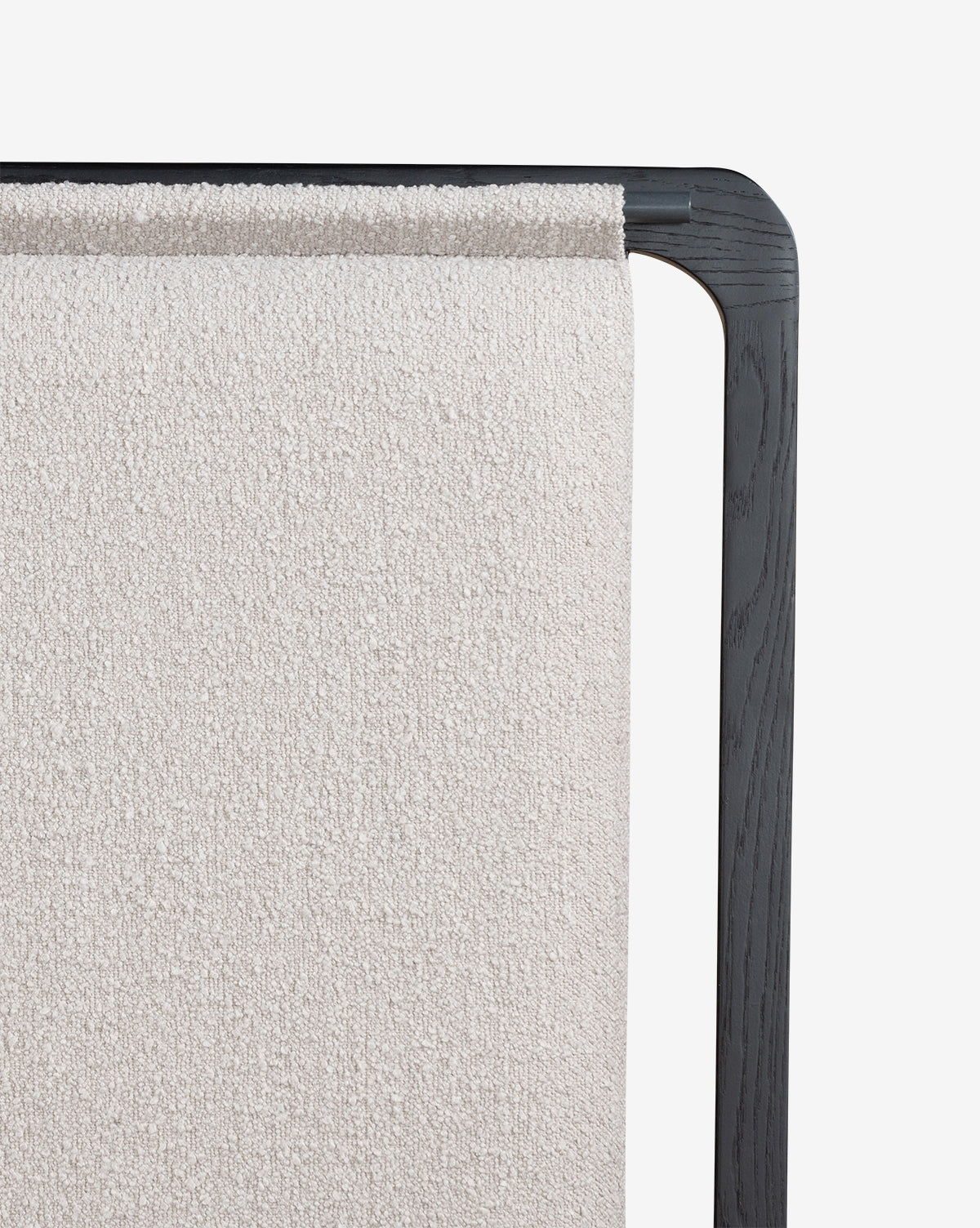 A close-up of the Hensley Bed with a black wooden frame and light, textured fabric accenting the headboard, highlighting its modern design against a plain white background.