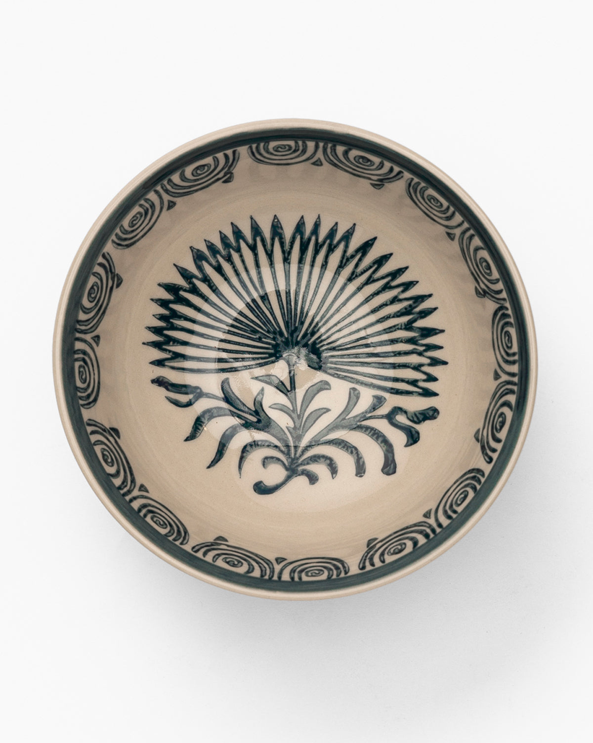 The Mattia Hand-Painted Bowl is a round glazed stoneware bowl with a beige base and dark blue fan-like center, plus floral swirl motifs around the rim, by McGee & Co.