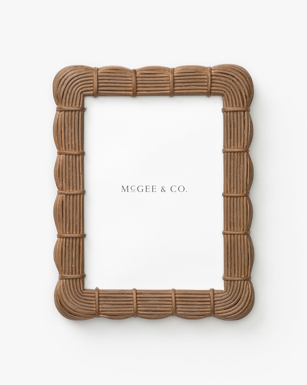 The Hilde Woven Frame is a rectangular brown picture frame featuring an organic woven texture, shown against a white background with a placeholder paper labeled MCGEE & CO.