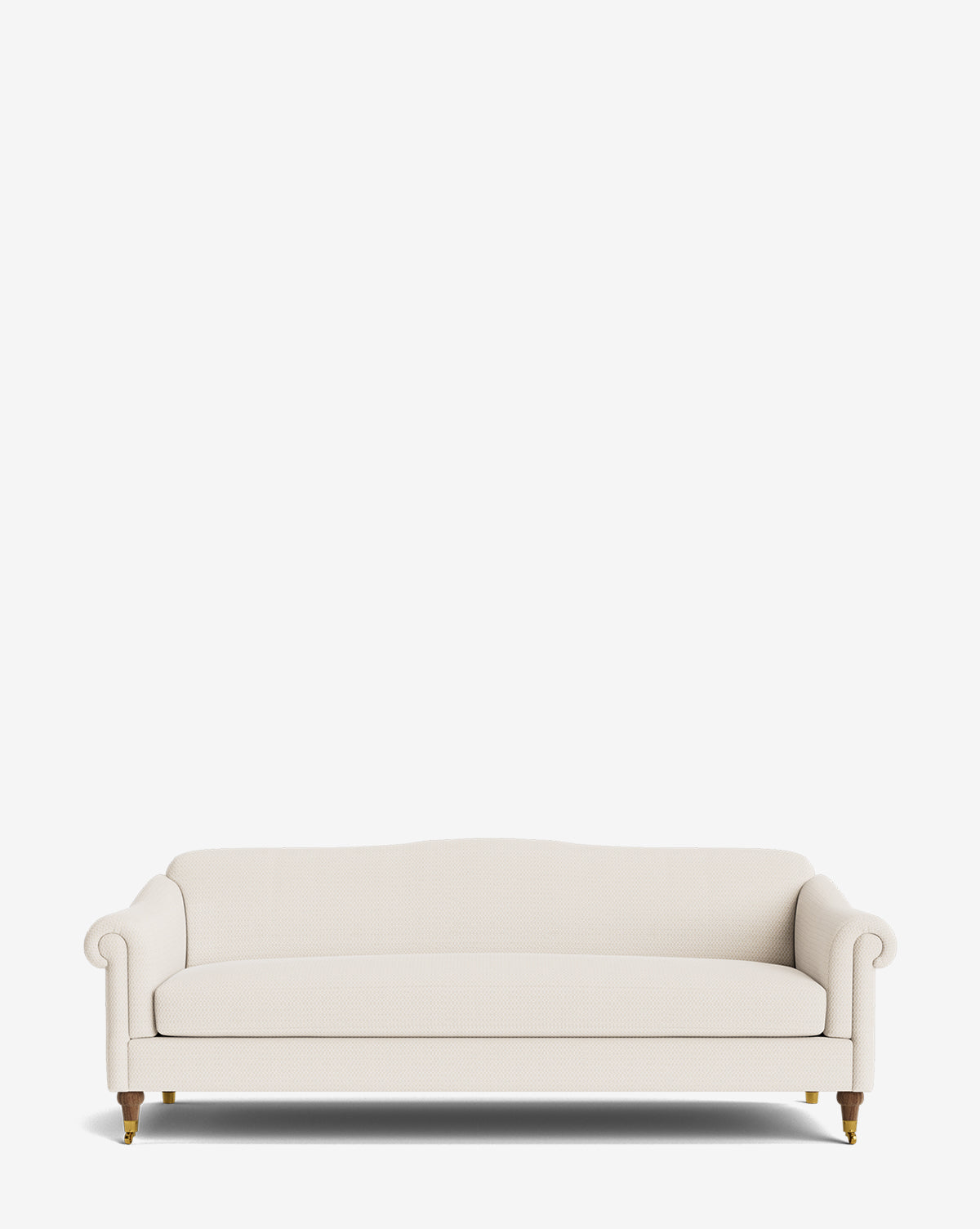 The Hildegard Sofa 90 is a cream upholstered, handcrafted sofa featuring rolled arms, a slightly curved backrest, and wooden legs with caster wheels, shown against a plain white background by McGee & Co.