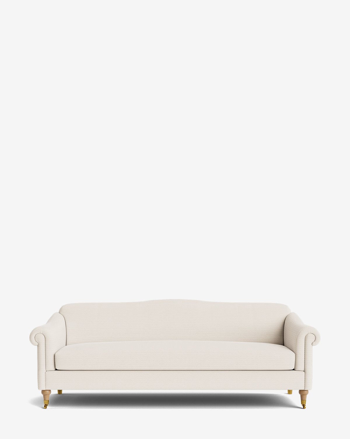 The Hildegard Sofa 90, a cream upholstered, handcrafted piece with rolled arms, wooden legs, and brass casters, is displayed against a plain white background by McGee & Co.