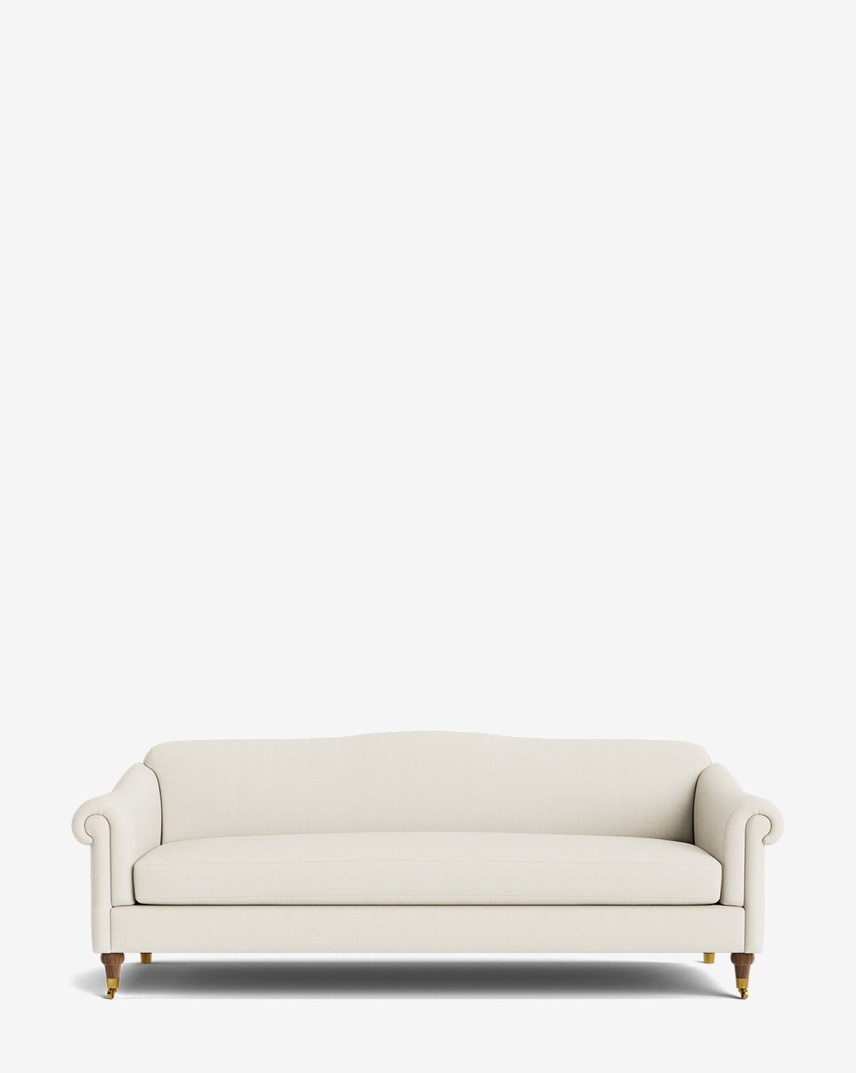The Hildegard Sofa 90 is a cream-colored, upholstered piece featuring rolled arms, wooden legs, and brass casters, shown handcrafted against a plain white background by McGee & Co.