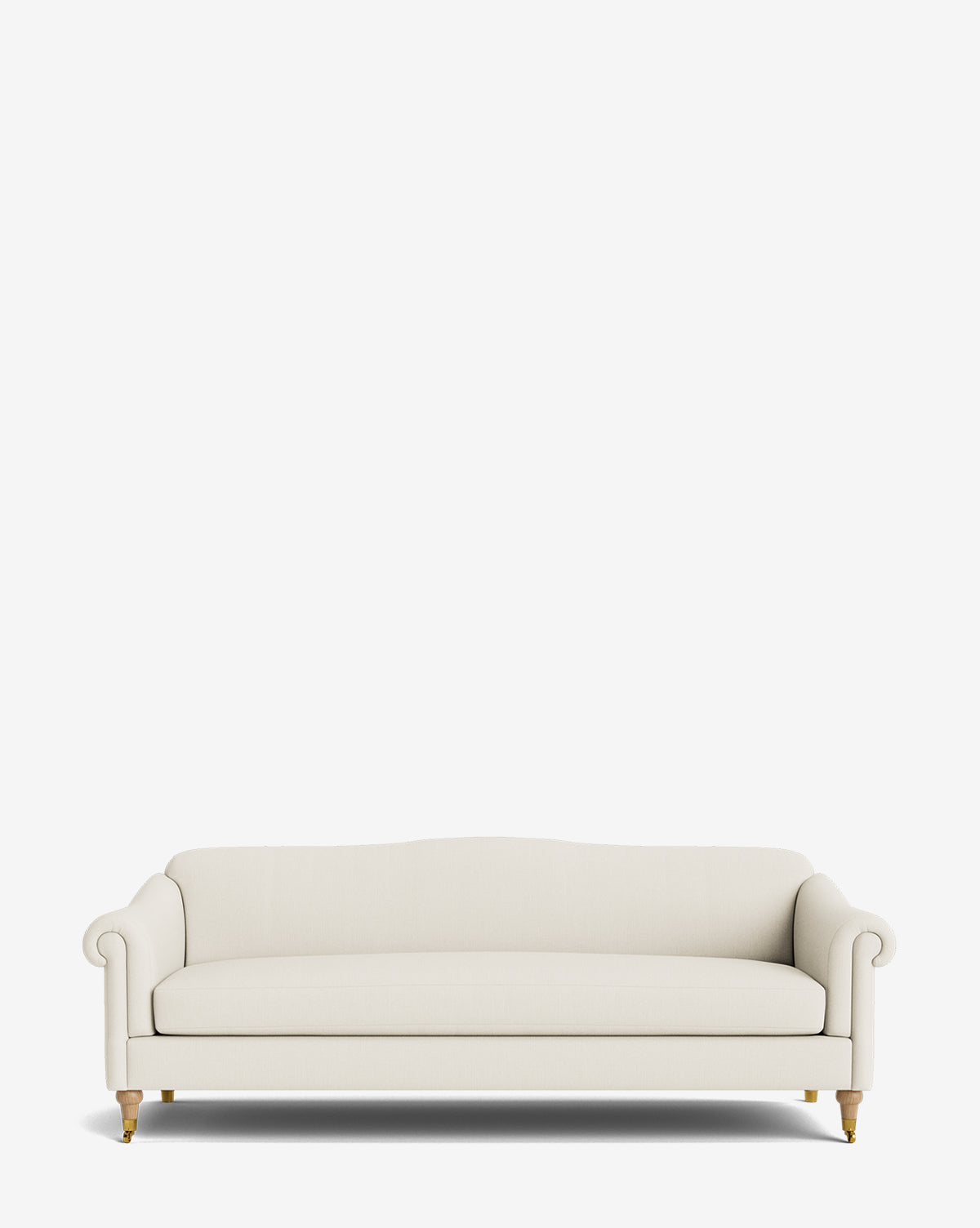The Hildegard Sofa 90 is a cream, three-seater handcrafted sofa with rolled arms and wooden legs with brass casters, shown on a plain white background, by McGee & Co.